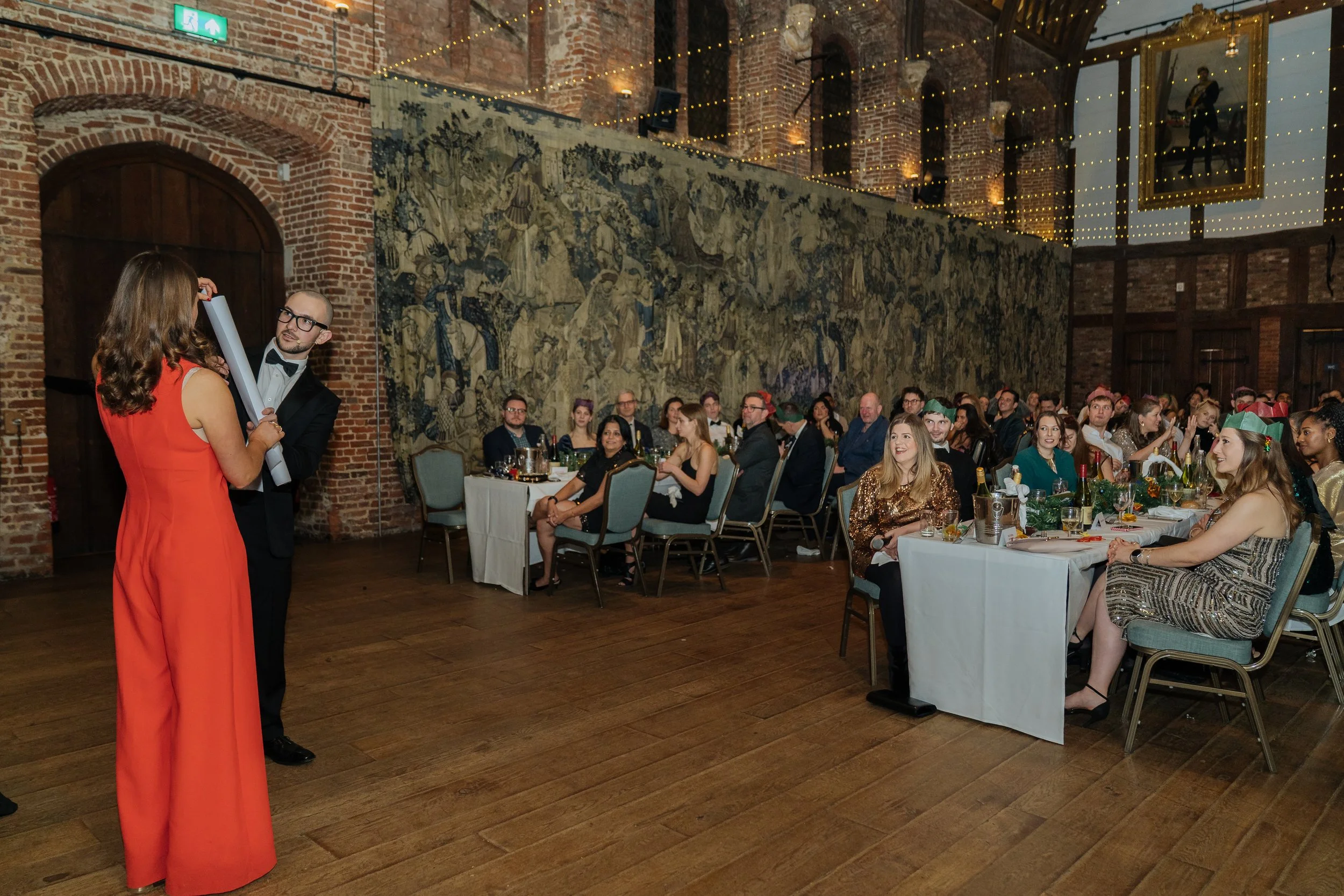 A corporate guest actively participating in a live magic performance, engaging with the magician on stage.