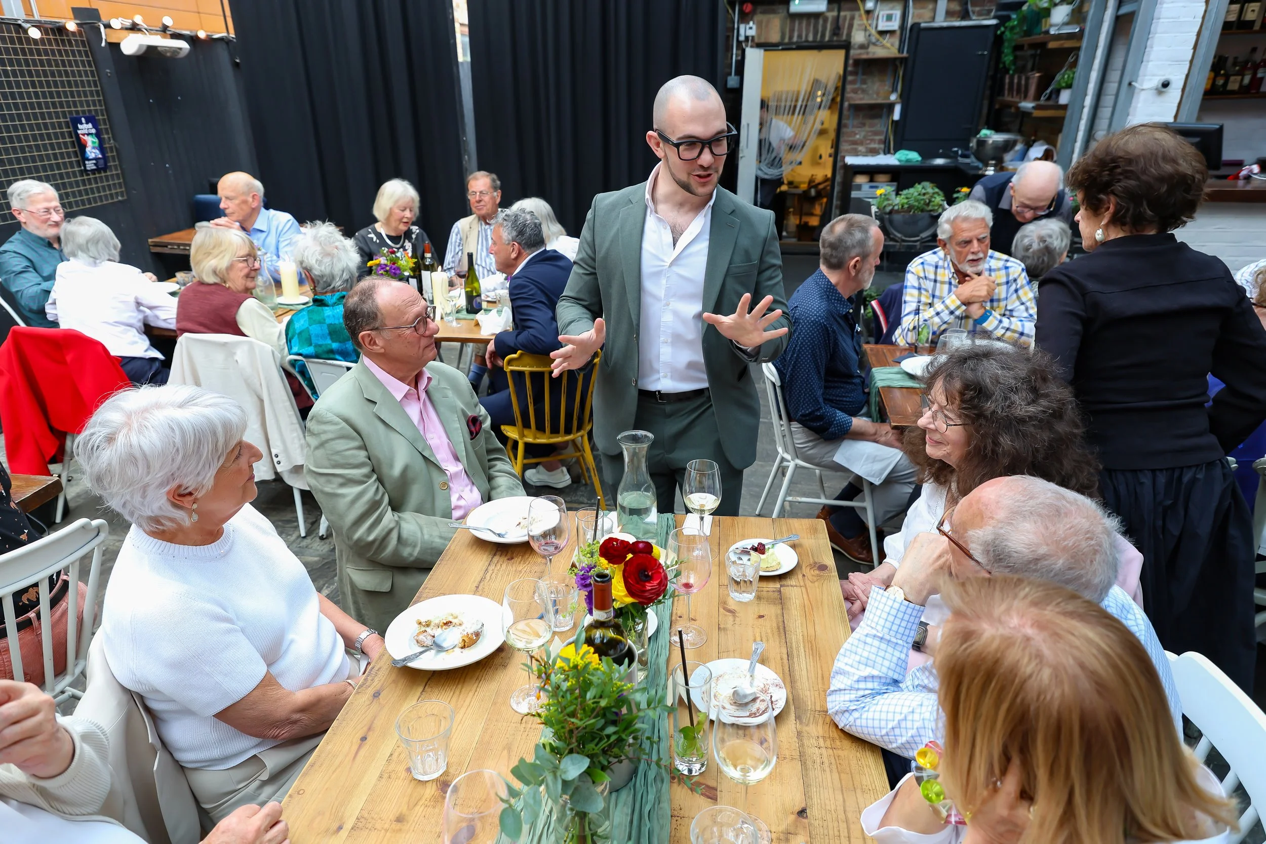 Guests participate with the Magician card tricks. 2026-May 3 Rhoda & Baruch Golden Anniversary. 