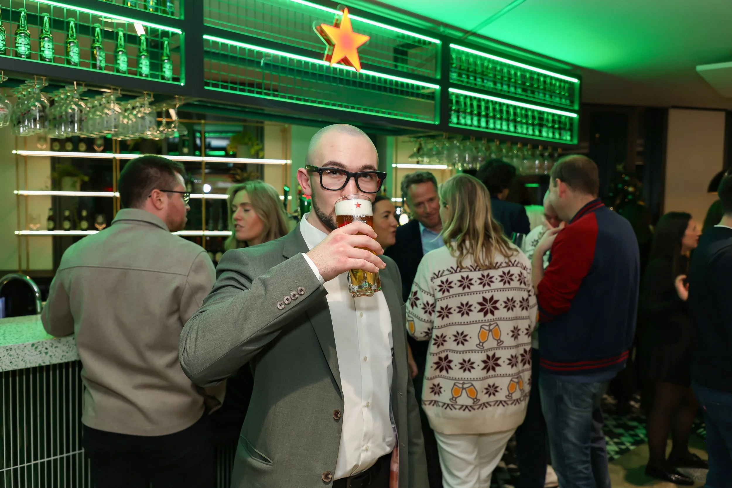 Professional magician enjoying a 0.0 company beverage during corporate event.