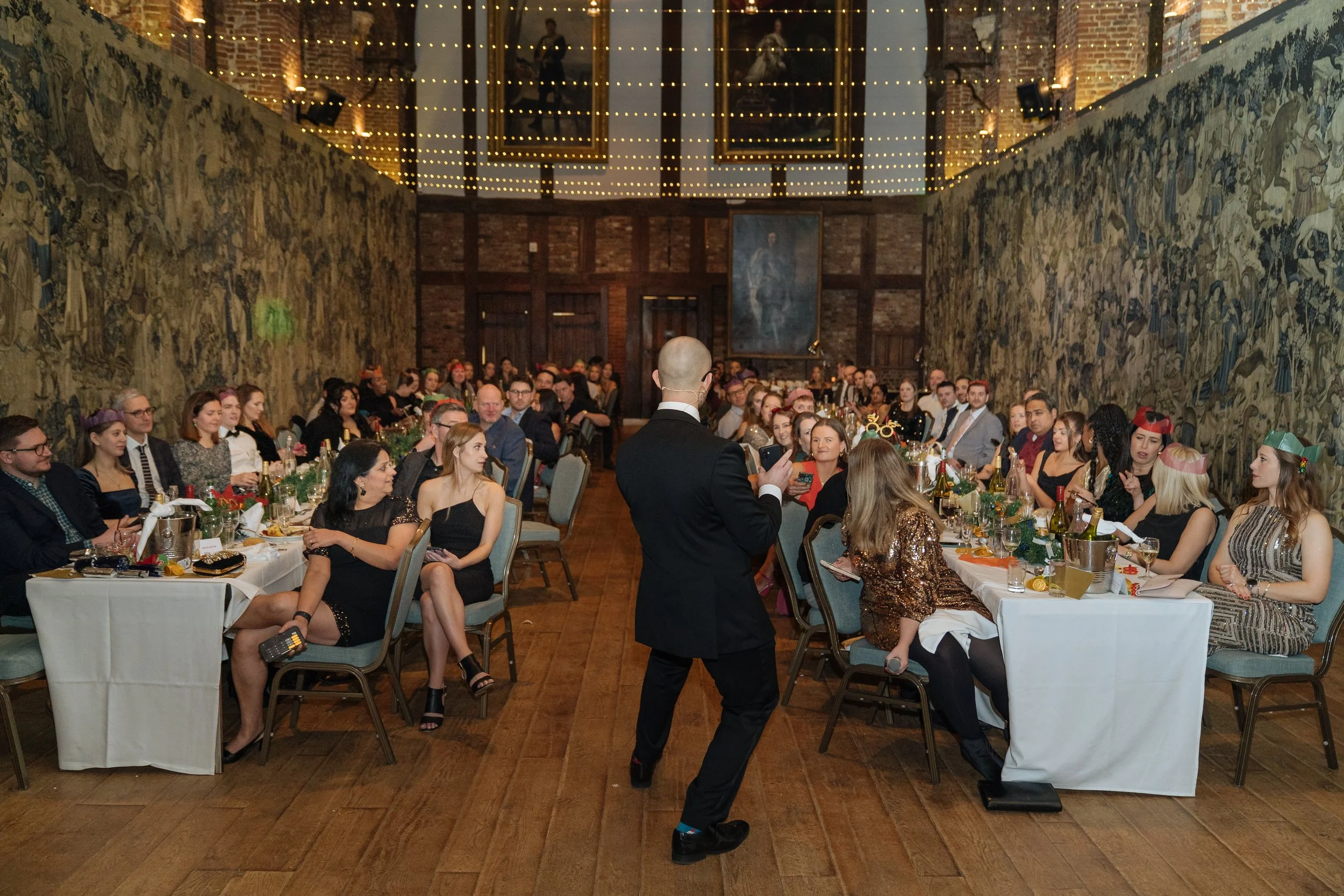 Magician entertaining corporate attendees during a formal company gala evening.