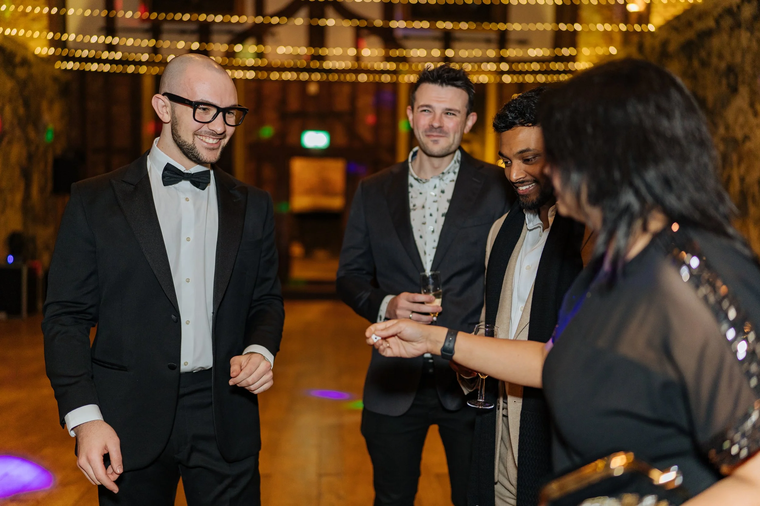 Corporate guests enjoying close-up magic during a formal corporate event.