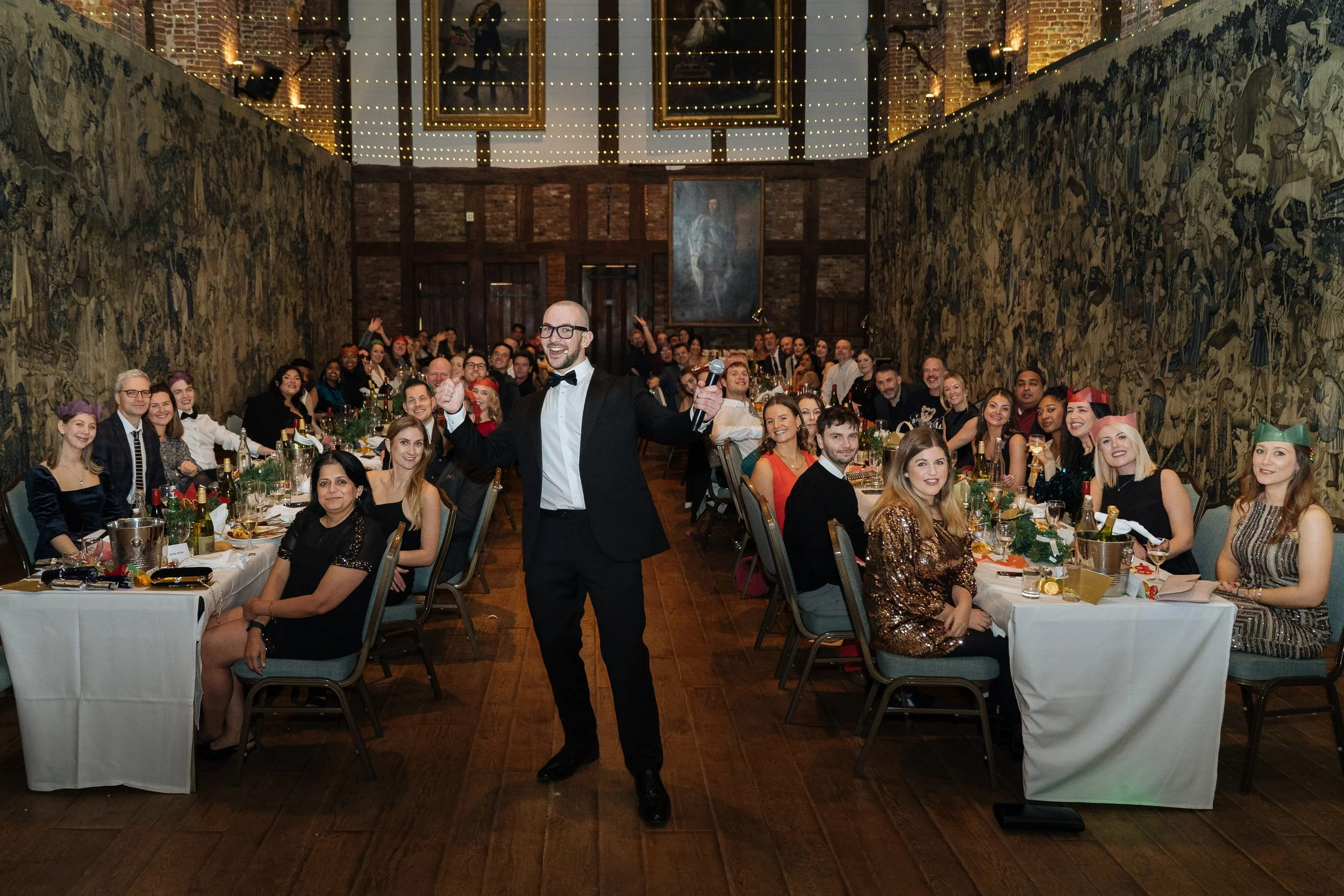 Corporate guests smiling and posing with the magician after enjoying a lively performance.
