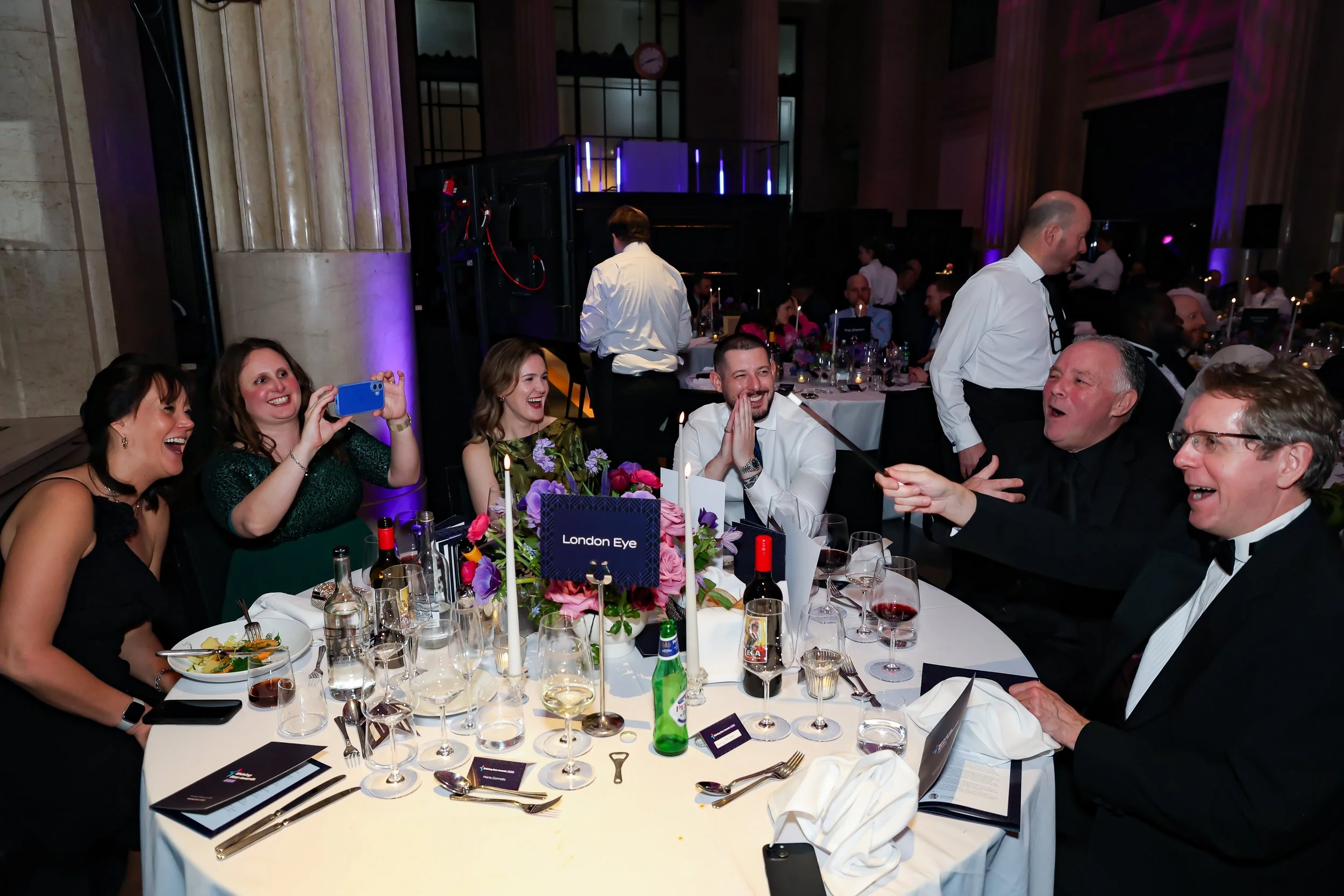 Close-up magic being performed for guests at their table, enhancing the dinner experience.