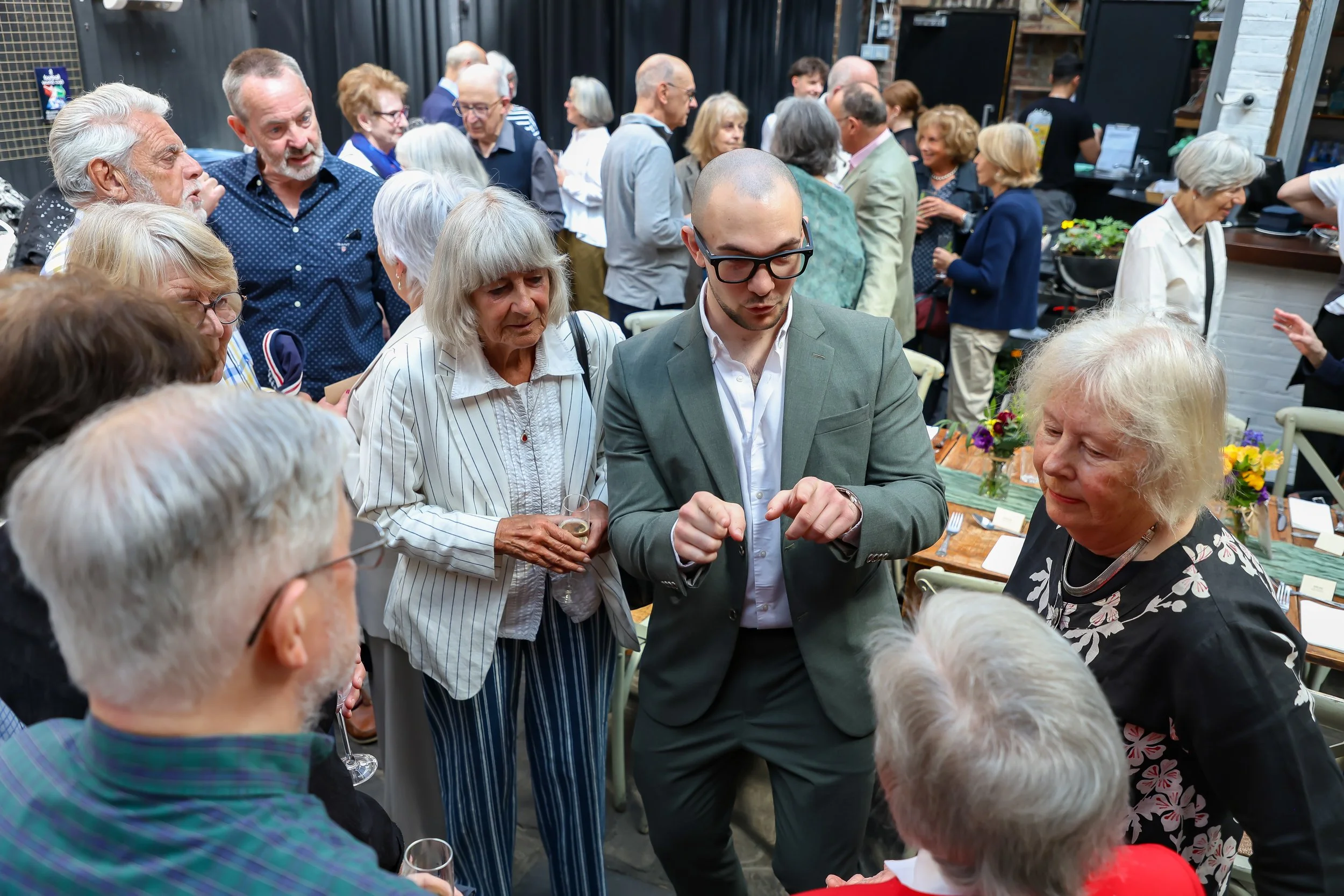 Magician with his card trick. 2026-May 3 Rhoda & Baruch Golden Wedding Anniversary. 
