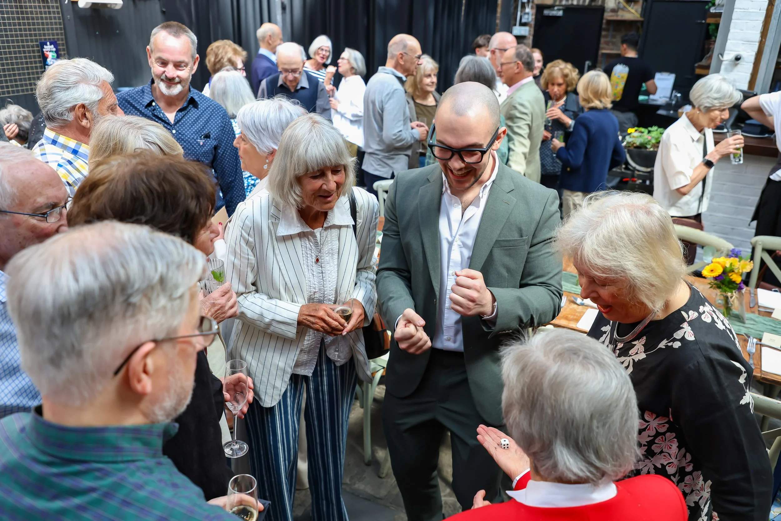 Magician with his card trick. 2026-May 3 Rhoda & Baruch Golden Wedding Anniversary. 