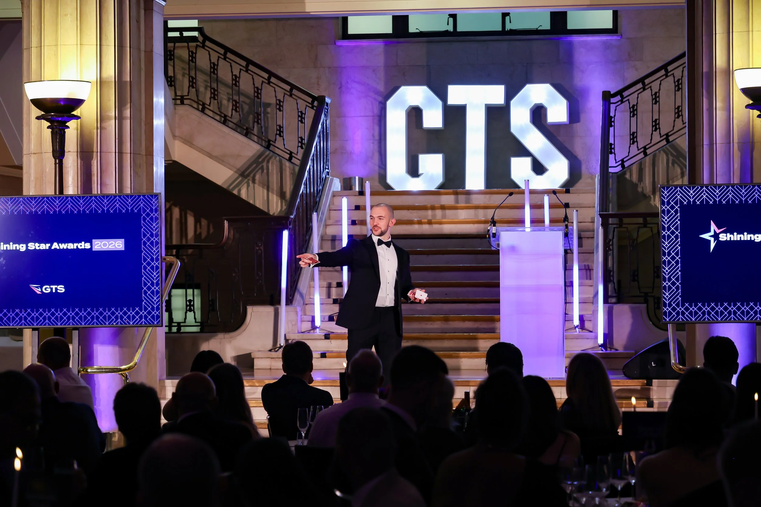 A charismatic event host guiding the programme with confidence, keeping the audience engaged and the event on track.