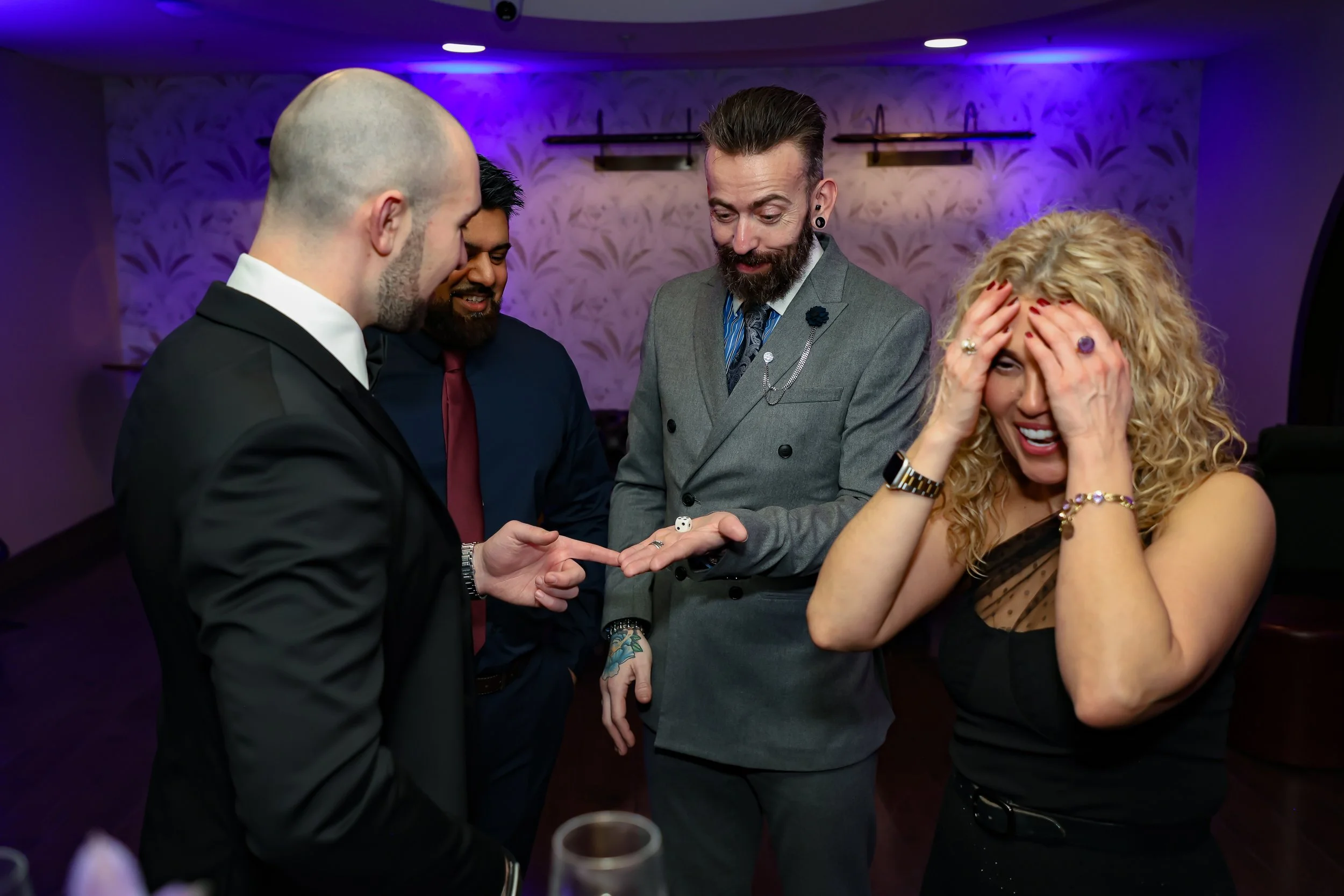 Magician captivating corporate employees with a close-up trick routine.