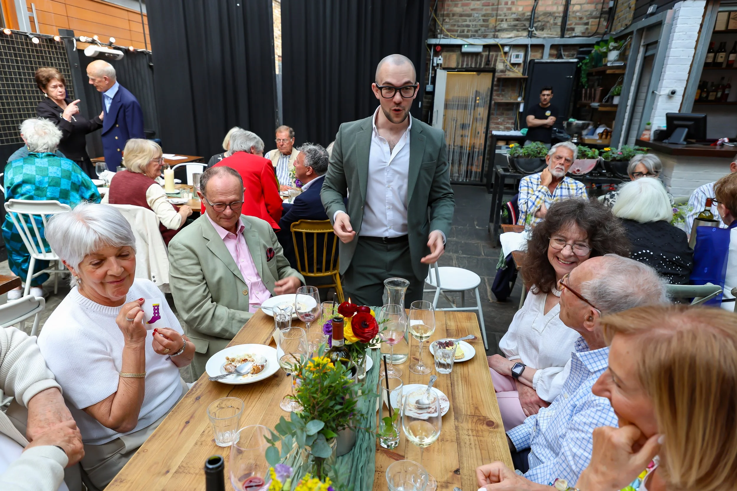 Guests participate with the Magician card tricks. 2026-May 3 Rhoda & Baruch Golden Anniversary. 