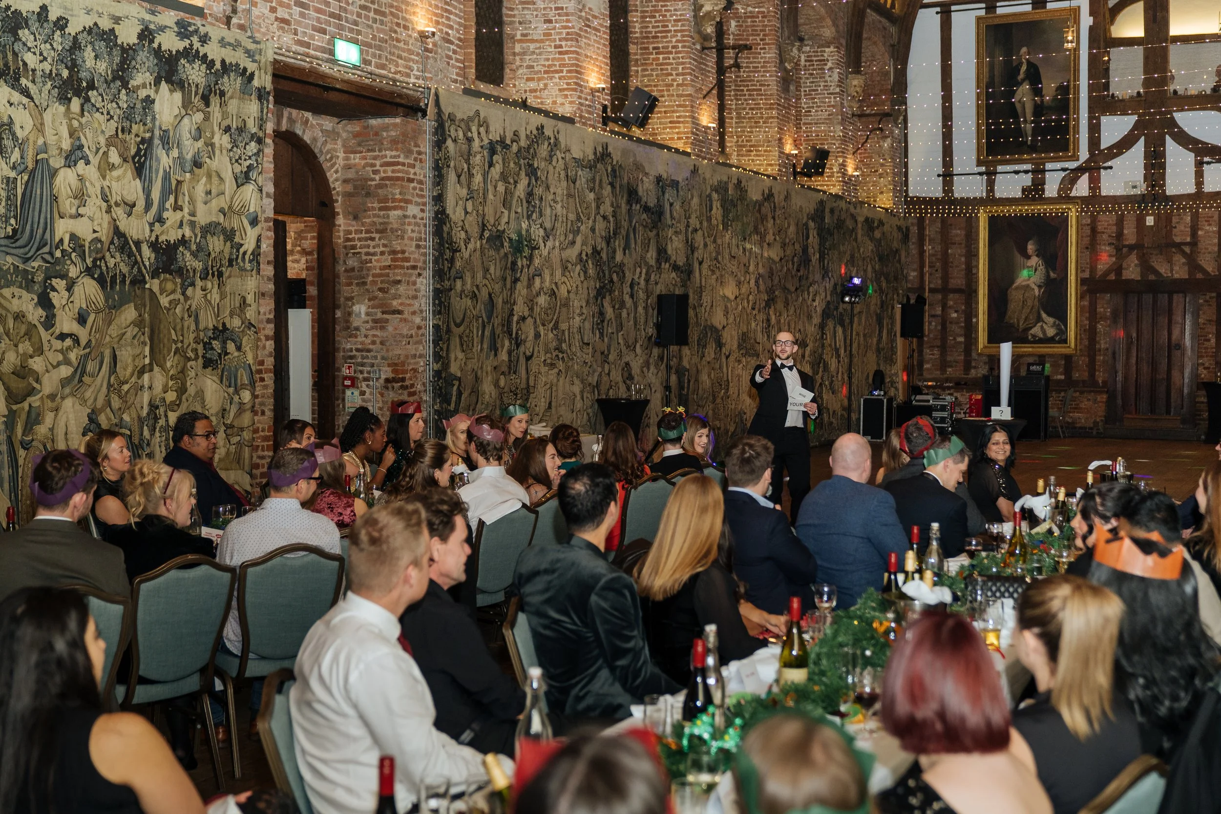 Corporate magician entertaining a full room of guests during a gala dinner.