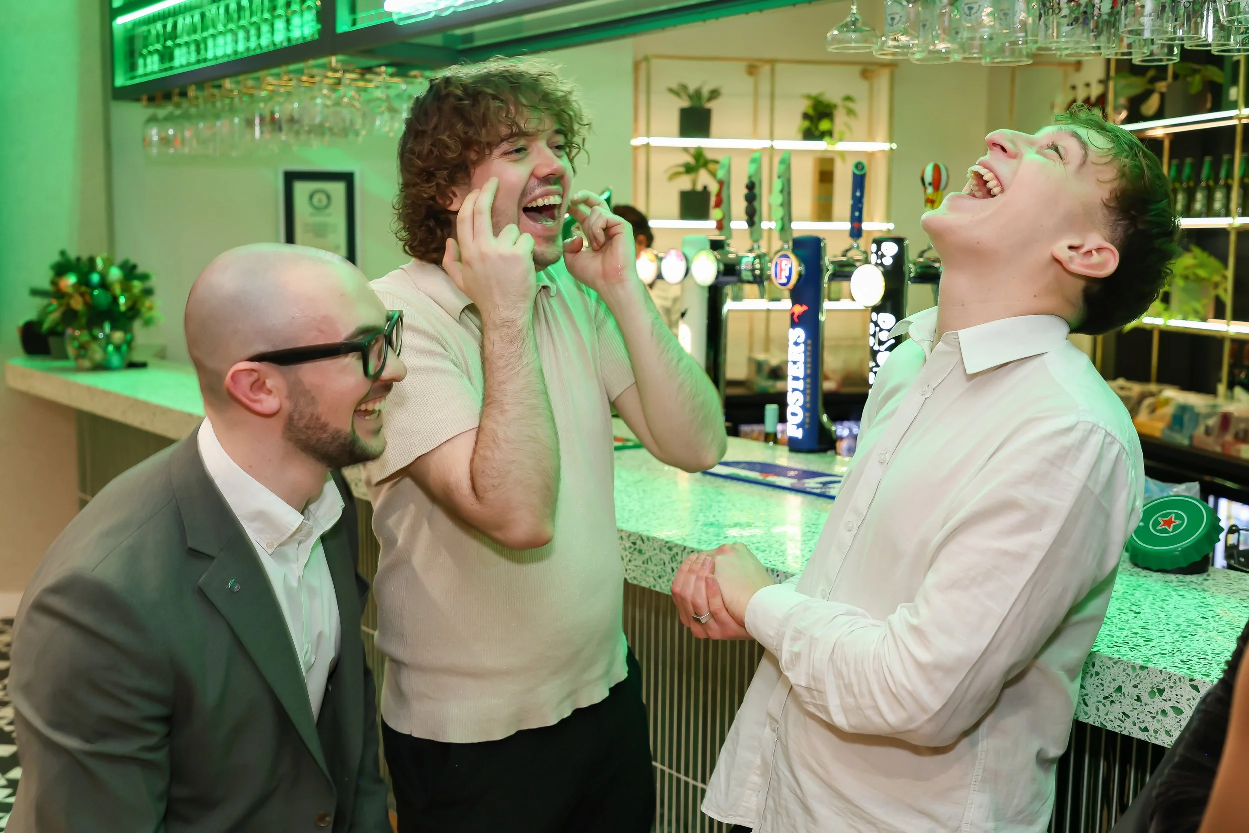 Walk-around magician entertaining colleagues with humour and close-up illusions at a corporate Christmas event.