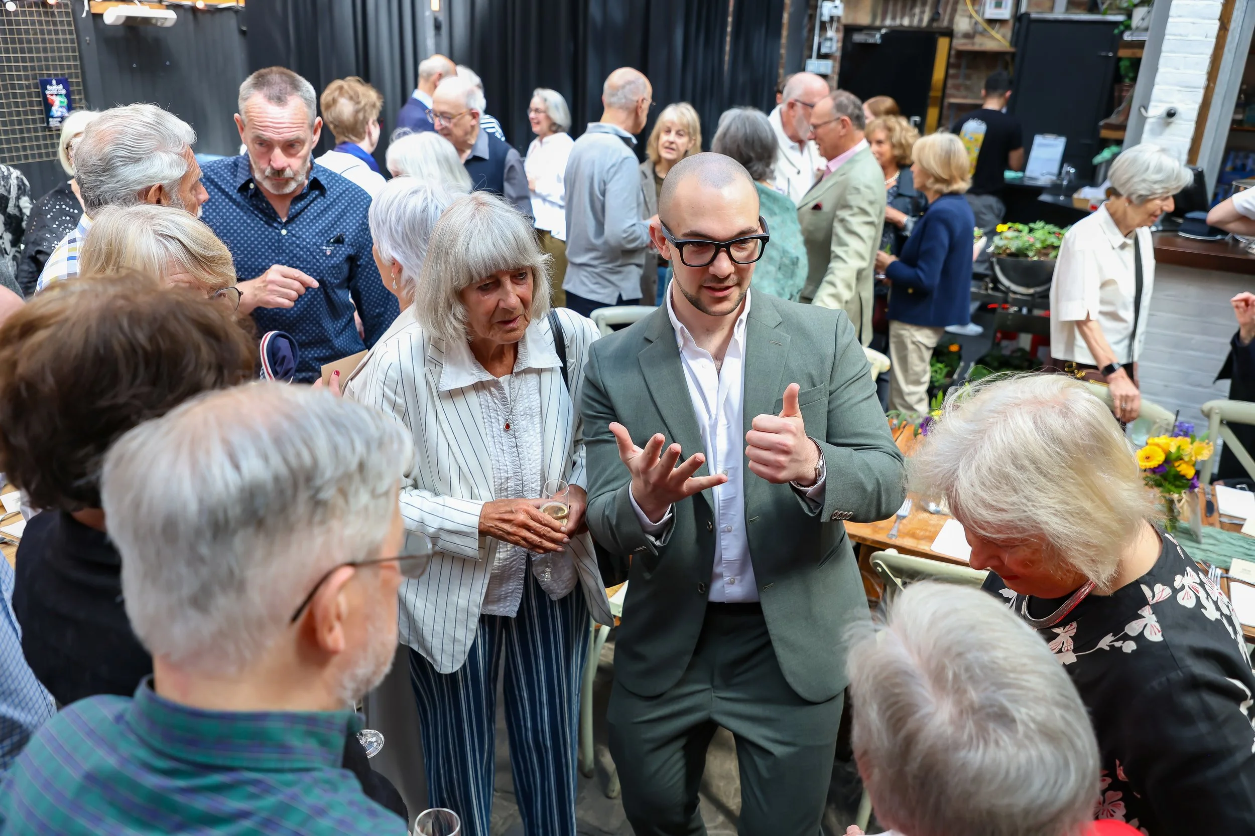 Magician with his card trick. 2026-May 3 Rhoda & Baruch Golden Wedding Anniversary. 