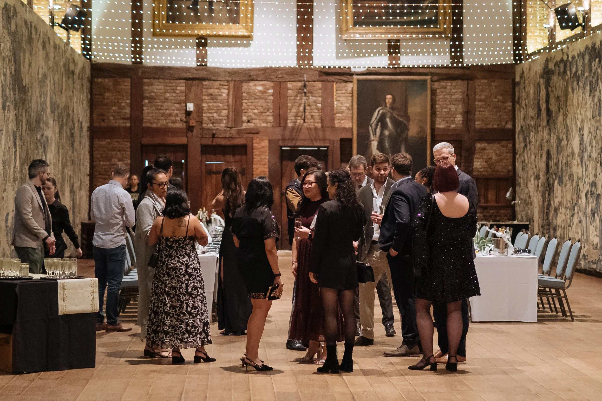 Corporate guests interacting at a formal evening event in London.