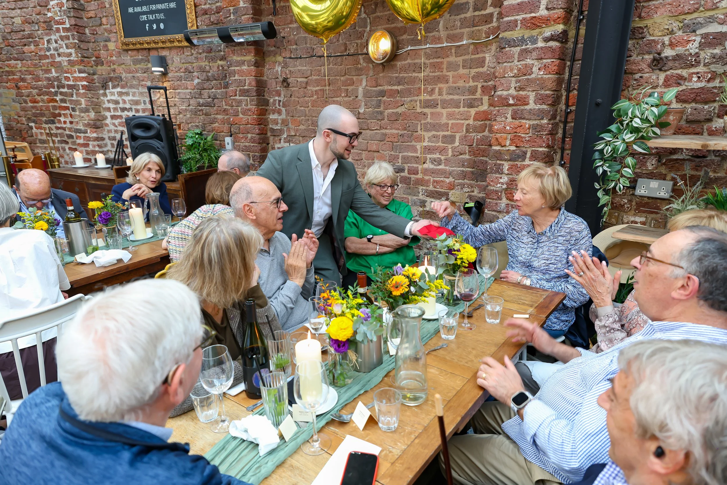 Guests participate on Magician mingling tricks. 2026-May 3 Rhoda & Baruch Golden Anniversary. 