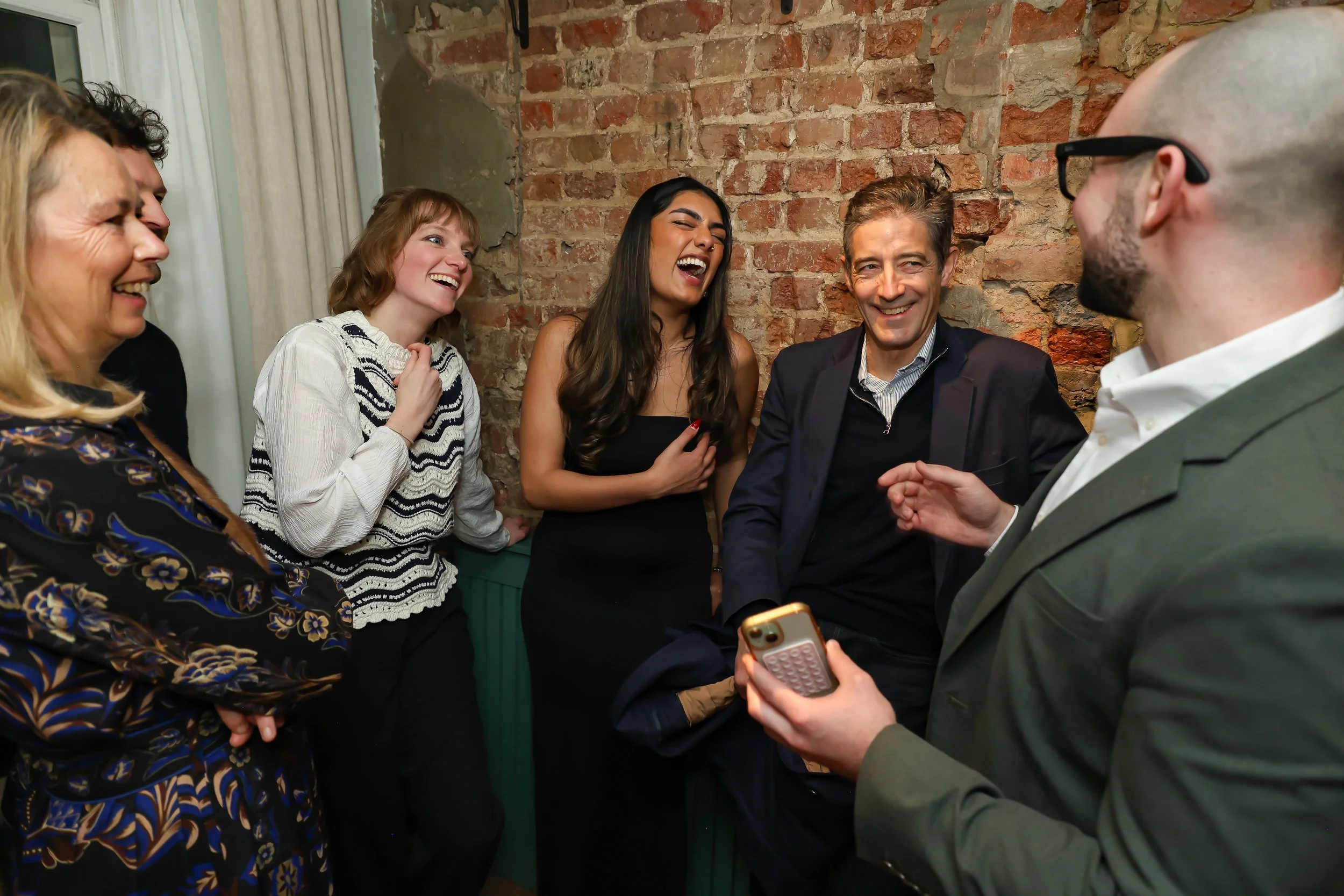 Guests celebrating a successful magic performance during a corporate reception.