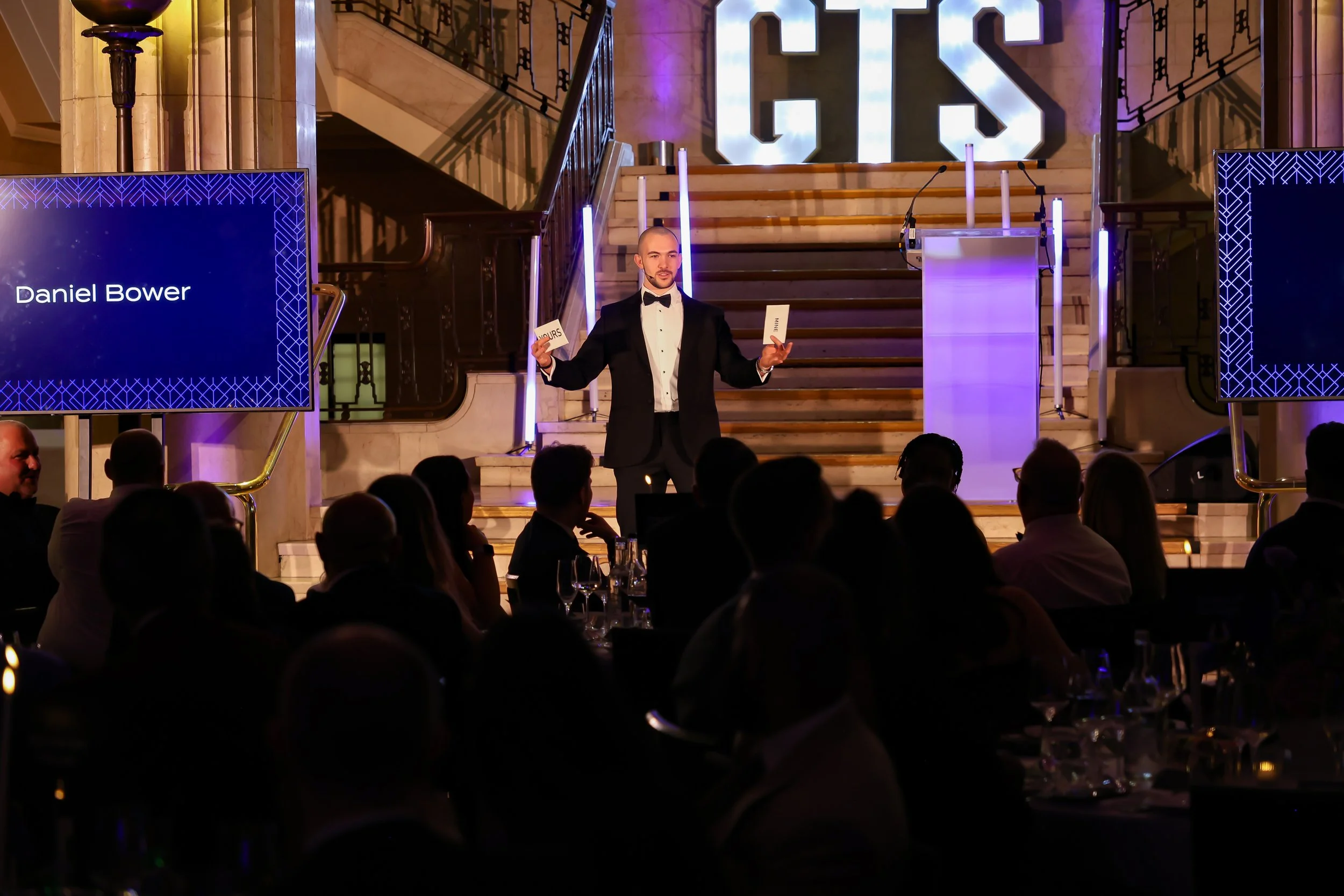 A skilled event host & magician balancing structure and spontaneity to keep the room energised and focused.