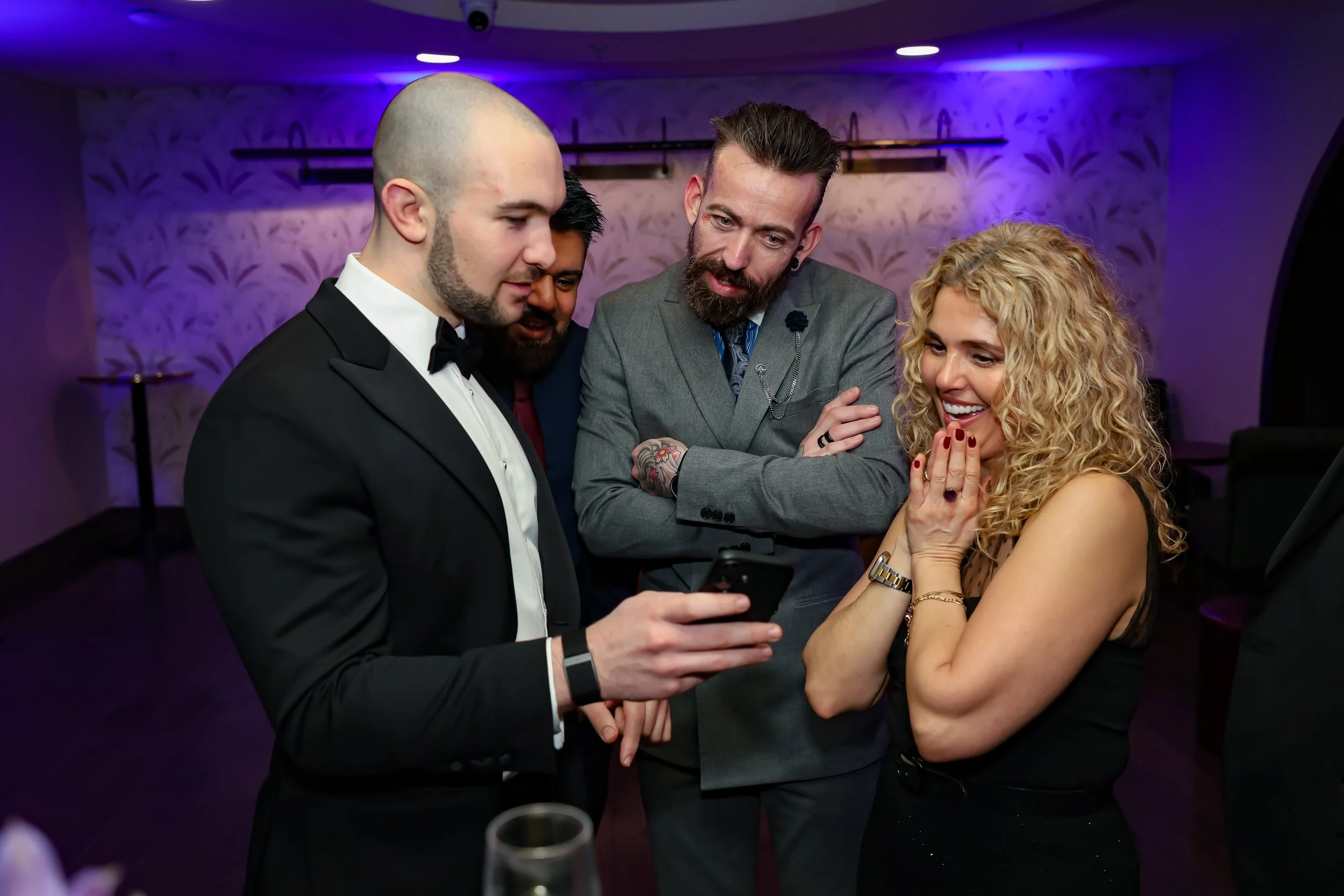 Magician captivating corporate employees with a close-up trick routine.