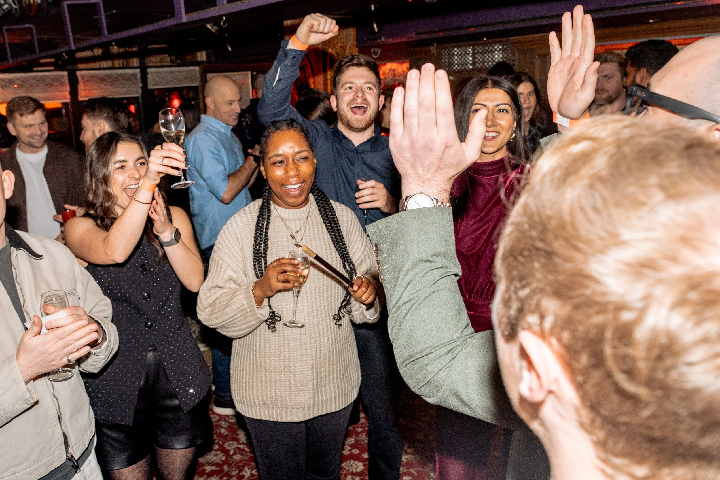 Guests enjoying live magic entertainment at company party.