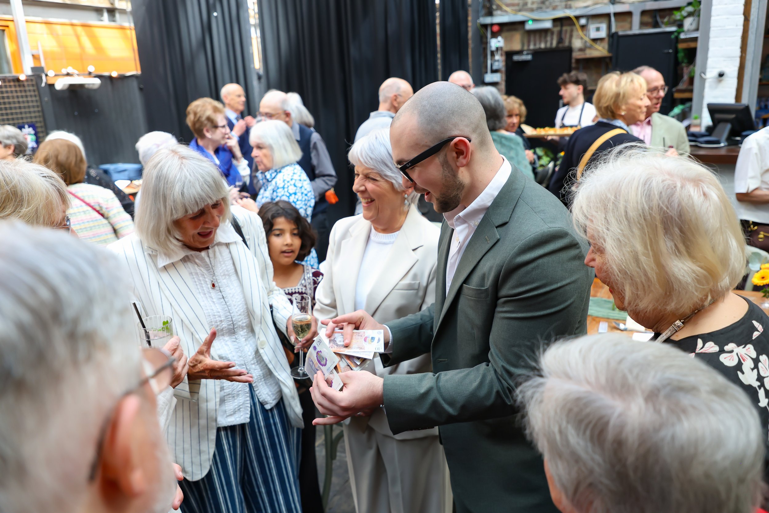 Magician with his card trick. 2026-May 3 Rhoda & Baruch Golden Wedding Anniversary. 