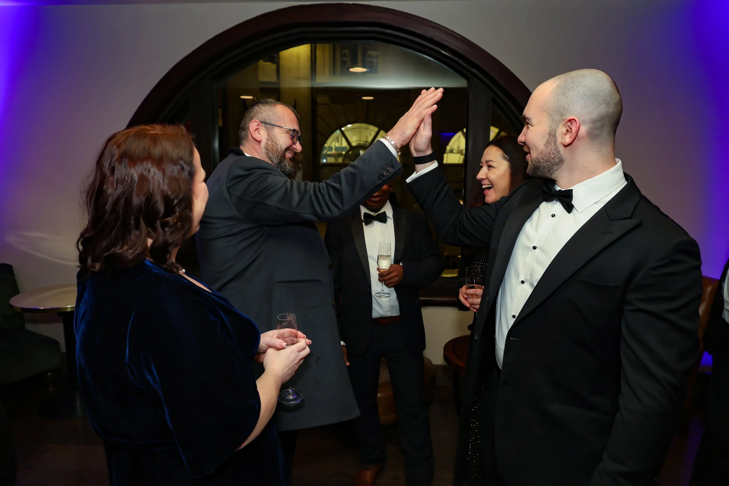 Corporate guests enjoying magic during corporate reception. 