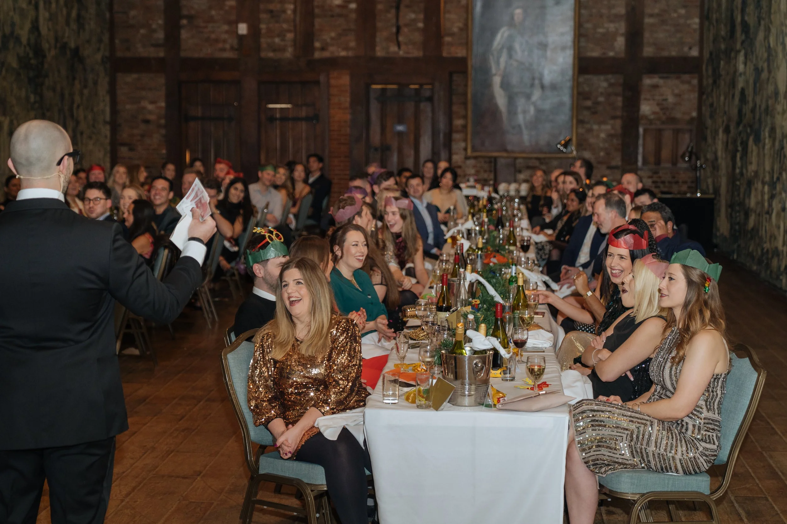 Magician entertaining corporate attendees during a formal company gala evening.