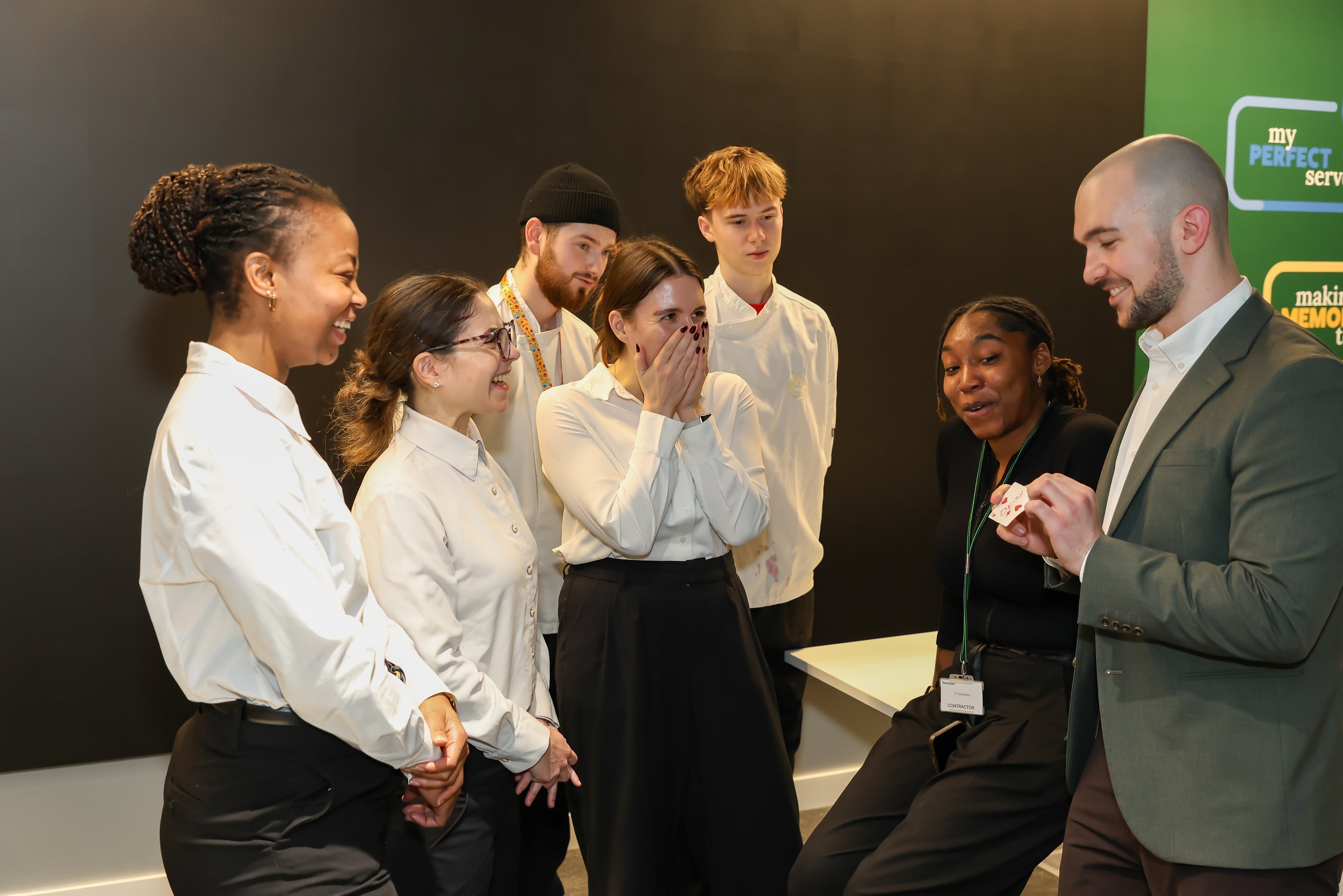 Laughter and amazement fill the room during an interactive magic moment.