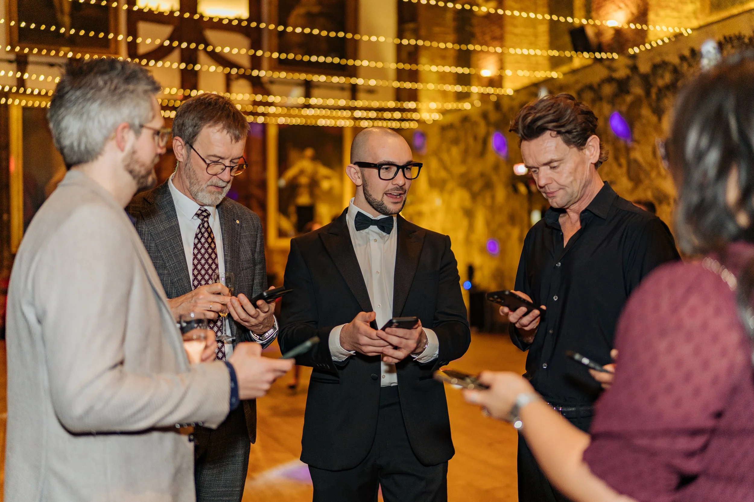 Interactive magician engaging business leaders during a formal company event.