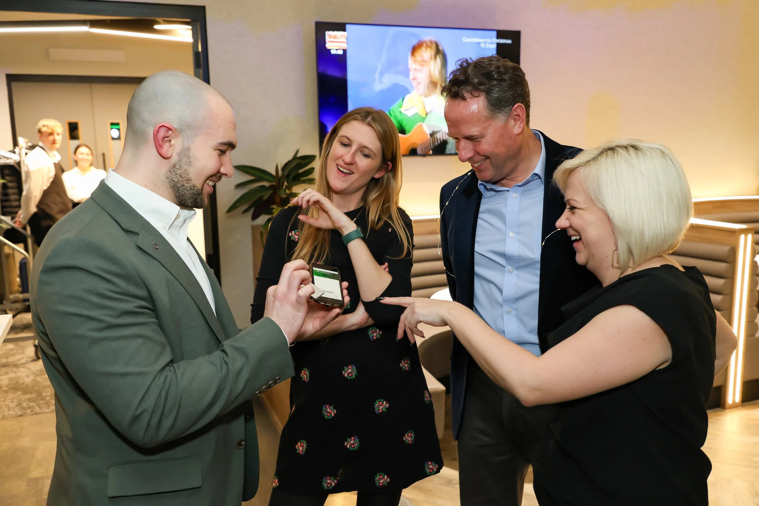 Guests watch in amazement as card tricks are performed by corporate magician. 