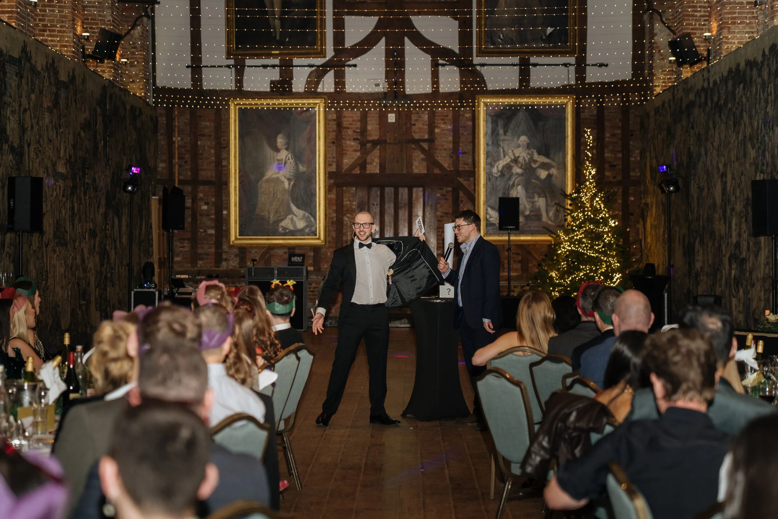 Magician involving a guest in an interactive trick during the corporate event, creating a memorable experience.
