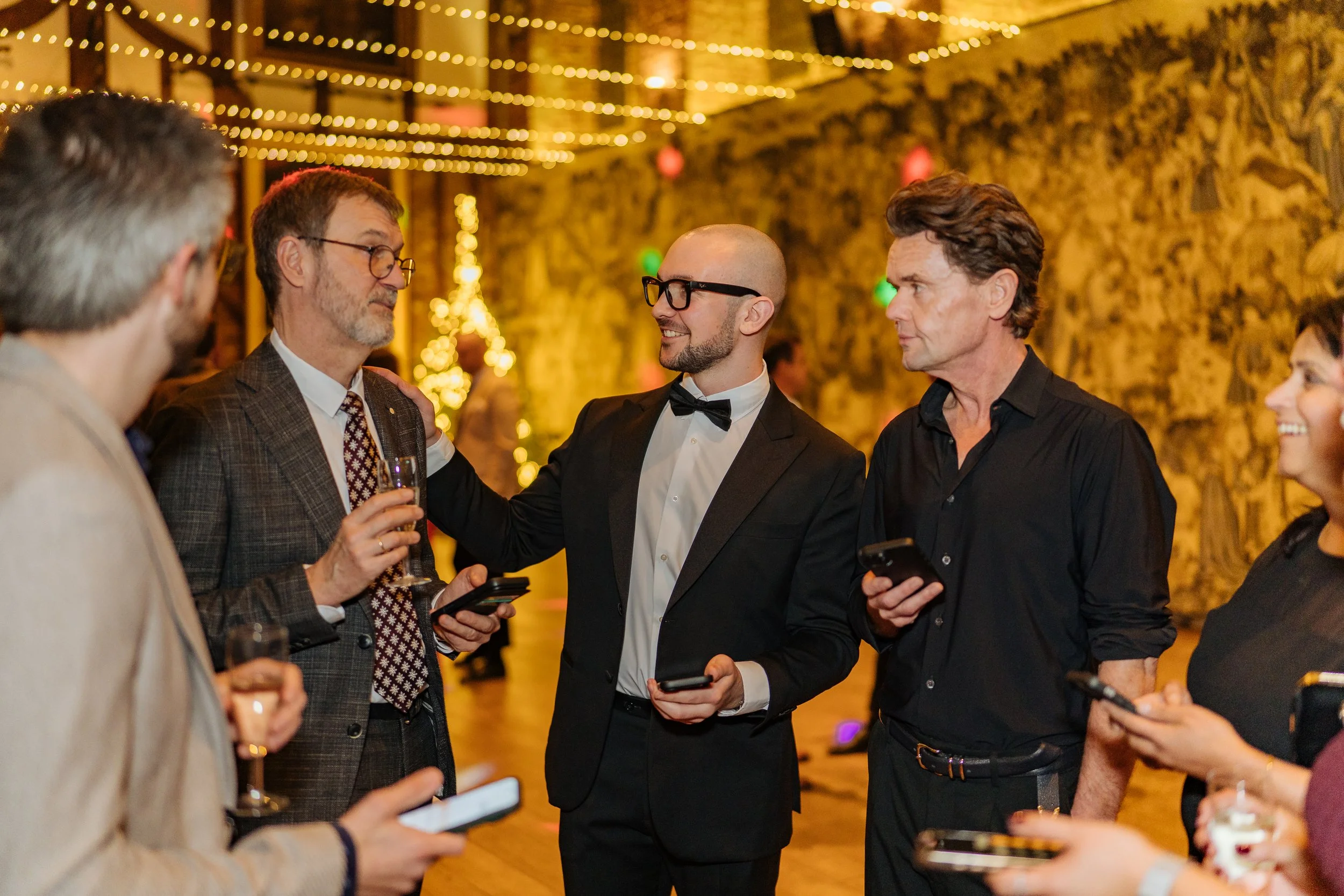 Interactive magician engaging business leaders during a formal company event.