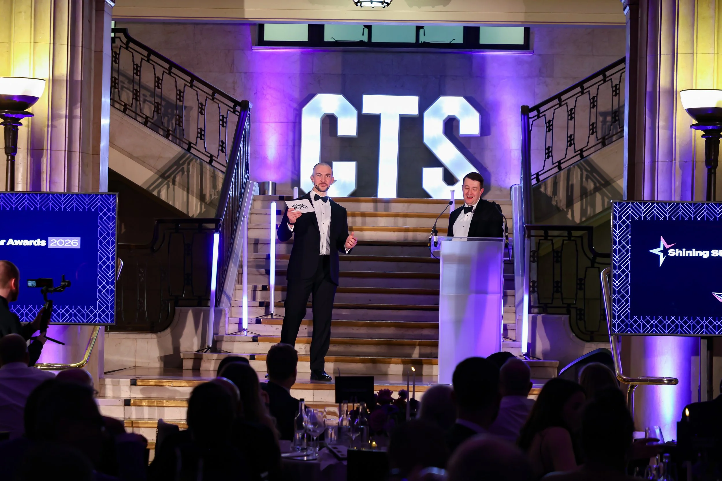 A magician engaging a guest on stage, creating a shared moment of wonder for the audience.