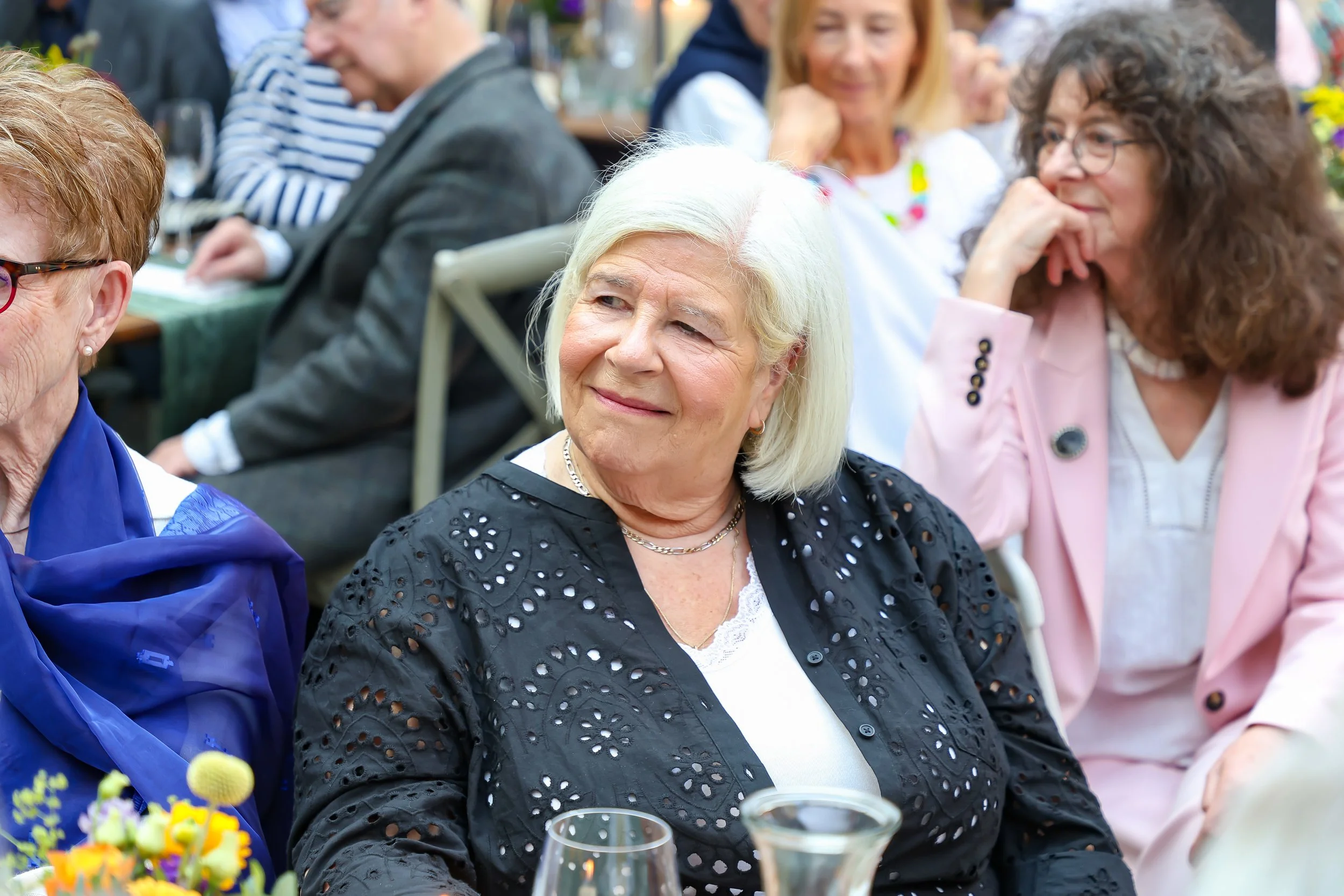 Listens attentively to Baruch on 2026-May 3 Rhoda & Baruch 50th Wedding Anniversary.