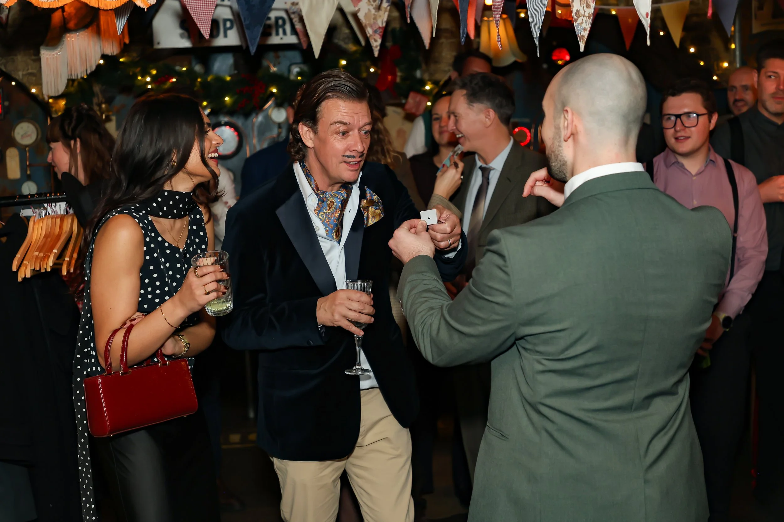 Guests enjoying hands-on interaction during a live magic show.