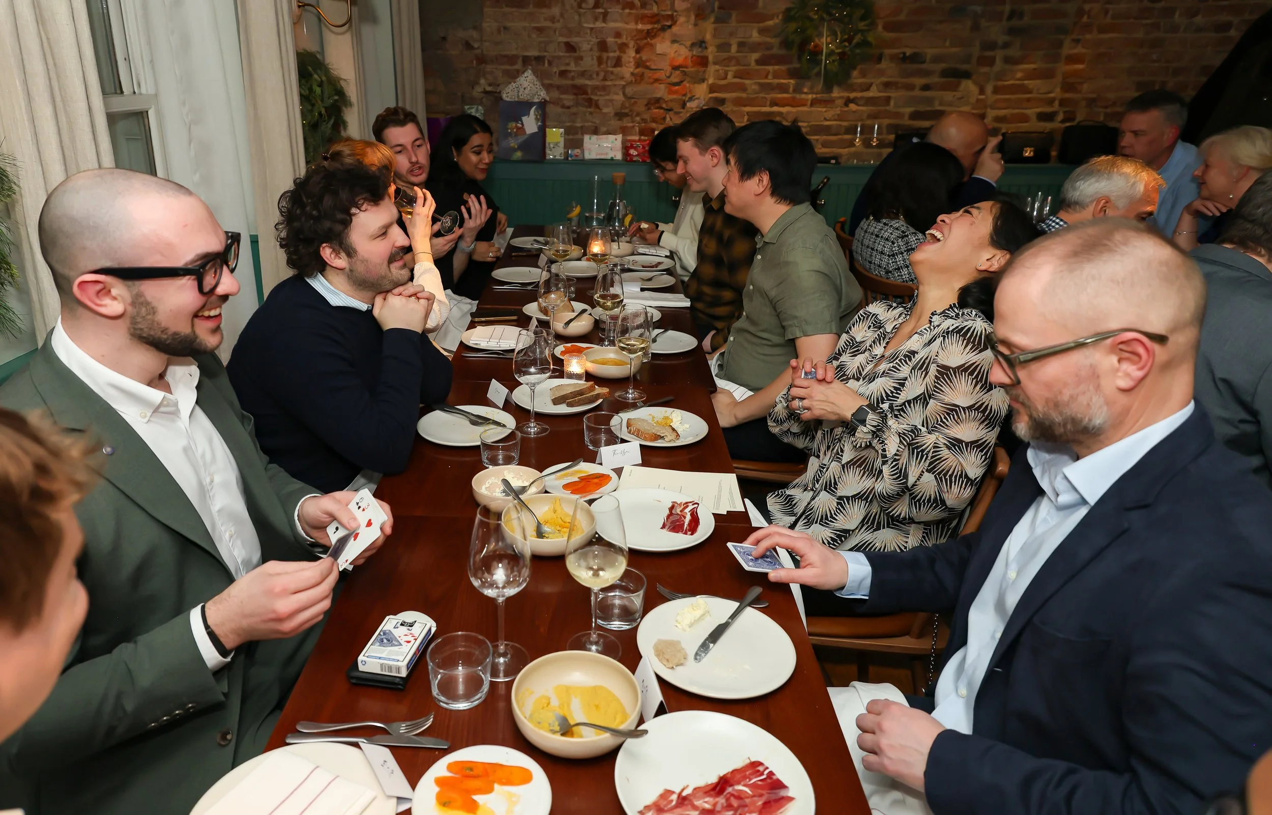 Magician engaging guests with interactive magic during a corporate dinner.