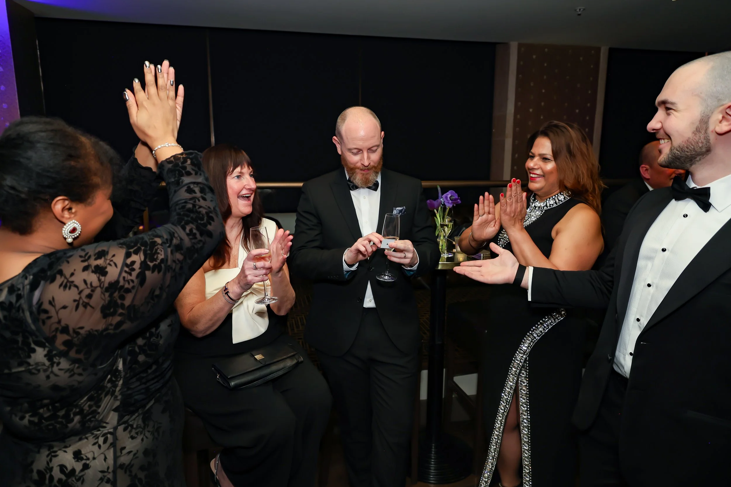 Corporate professionals enjoying with a live performance by the magician during reception.