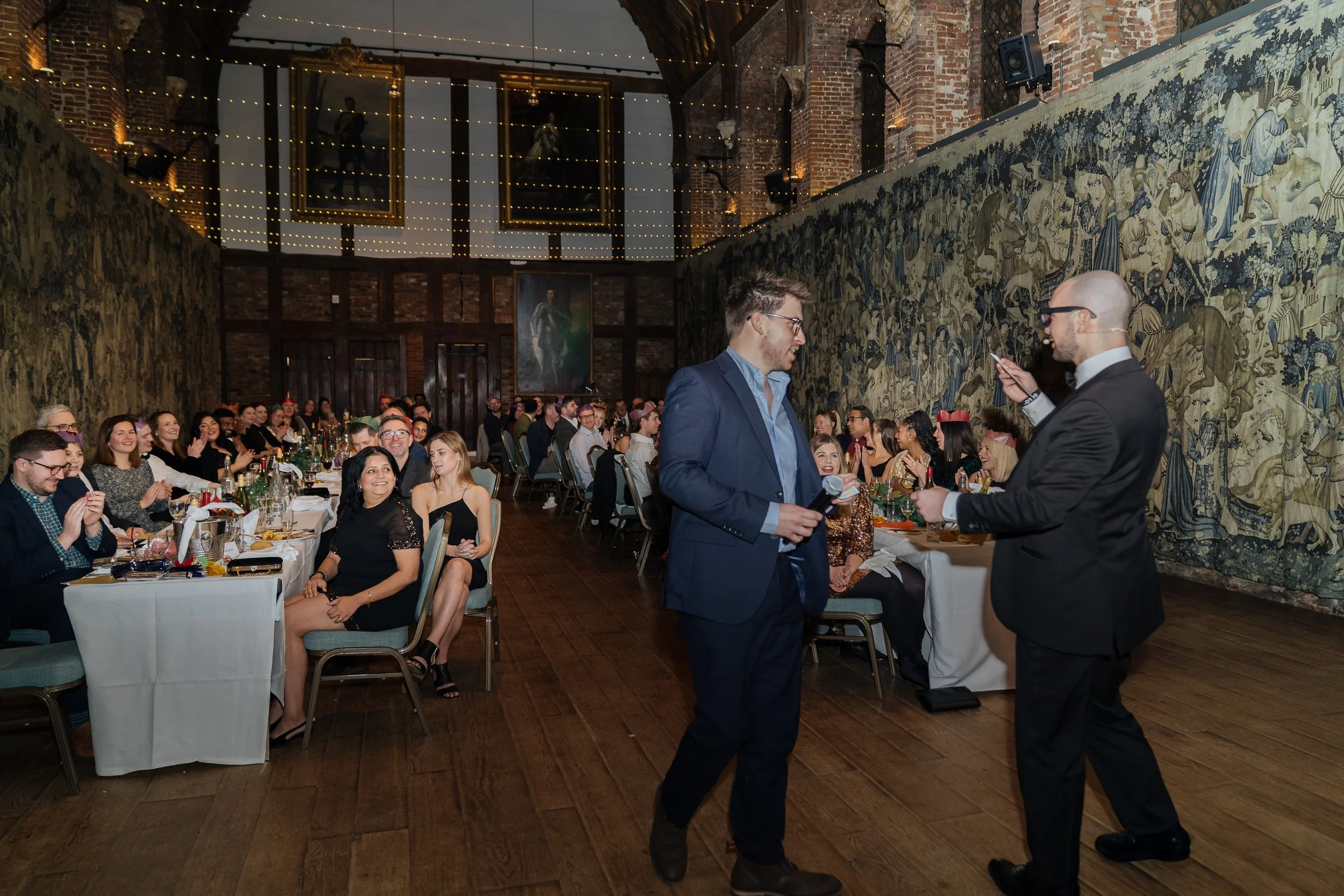 A corporate guest actively participating in a live magic performance, engaging with the magician on stage.
