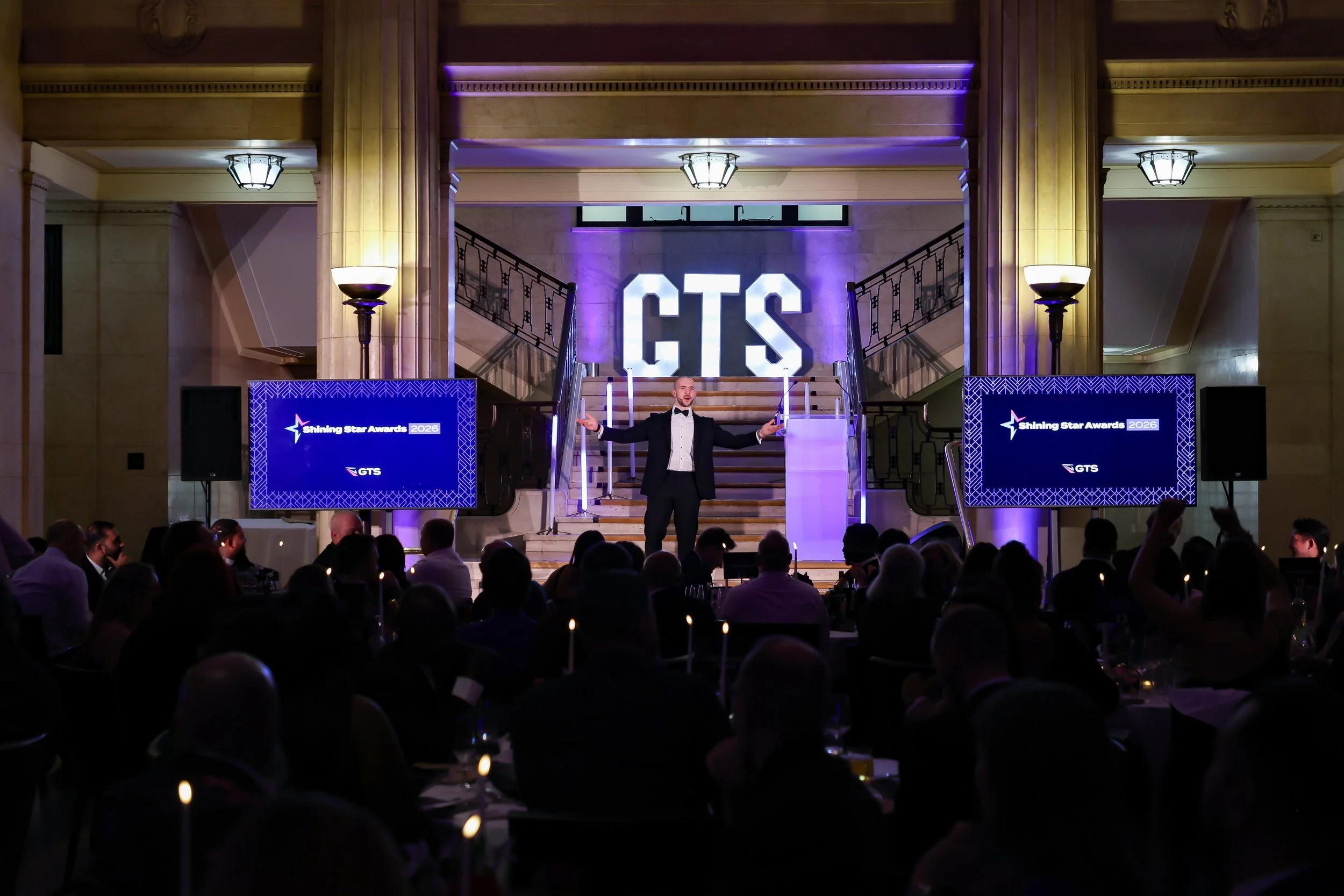 A charismatic event host guiding the programme with confidence, keeping the audience engaged and the event on track.