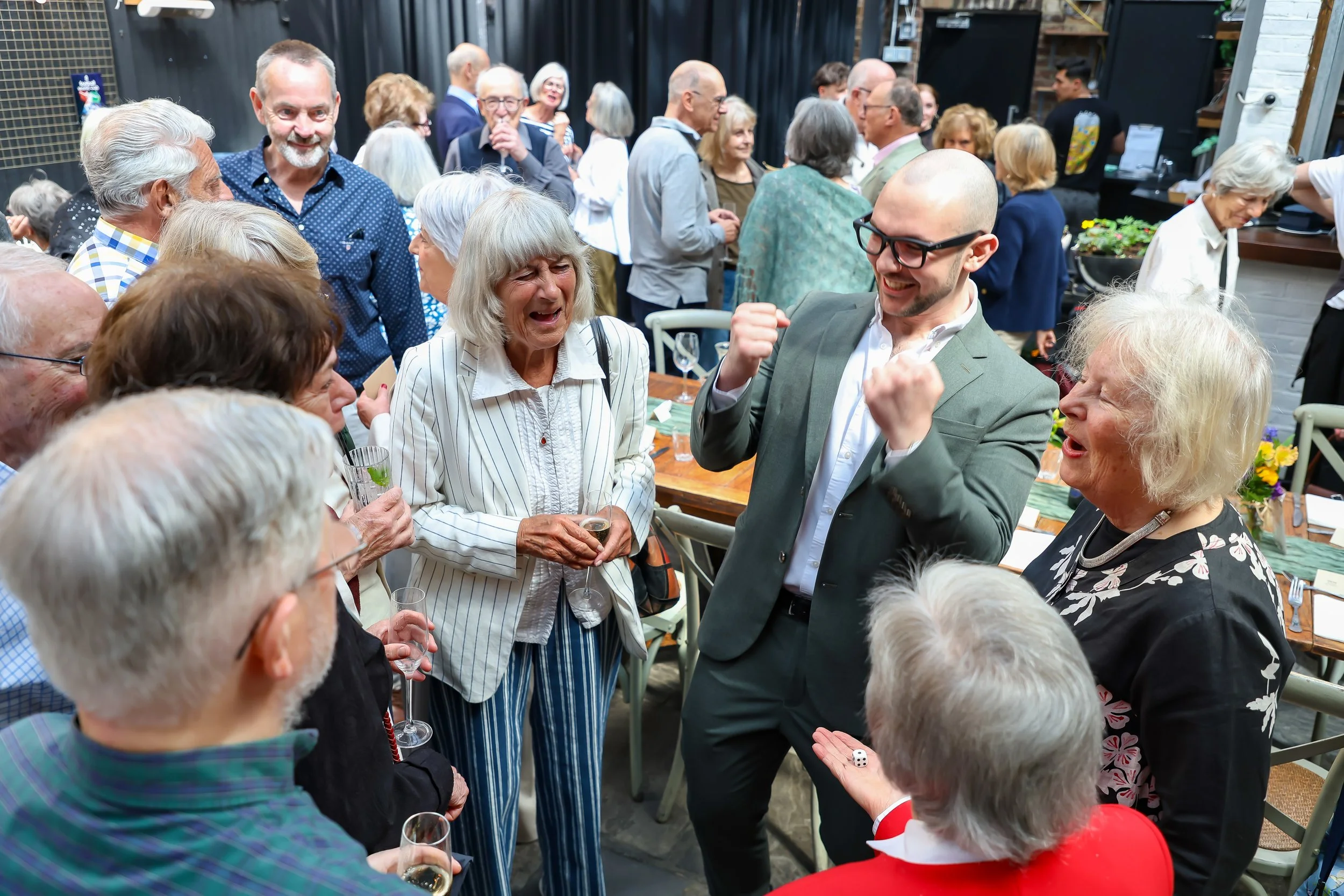 Magician with his card trick. 2026-May 3 Rhoda & Baruch Golden Wedding Anniversary. 
