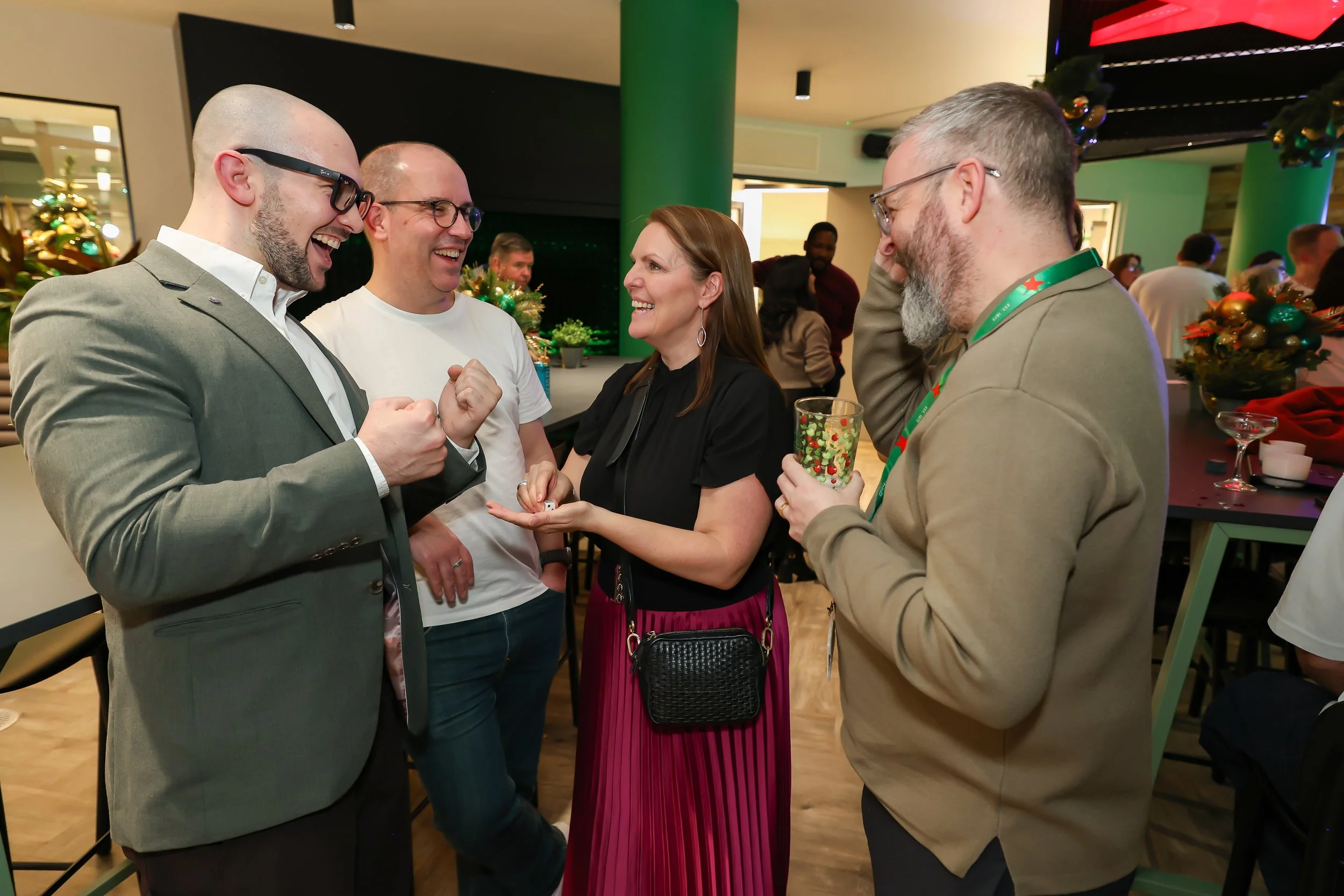 London magician presents a close-up illusion as corporate guests watch in amazement.