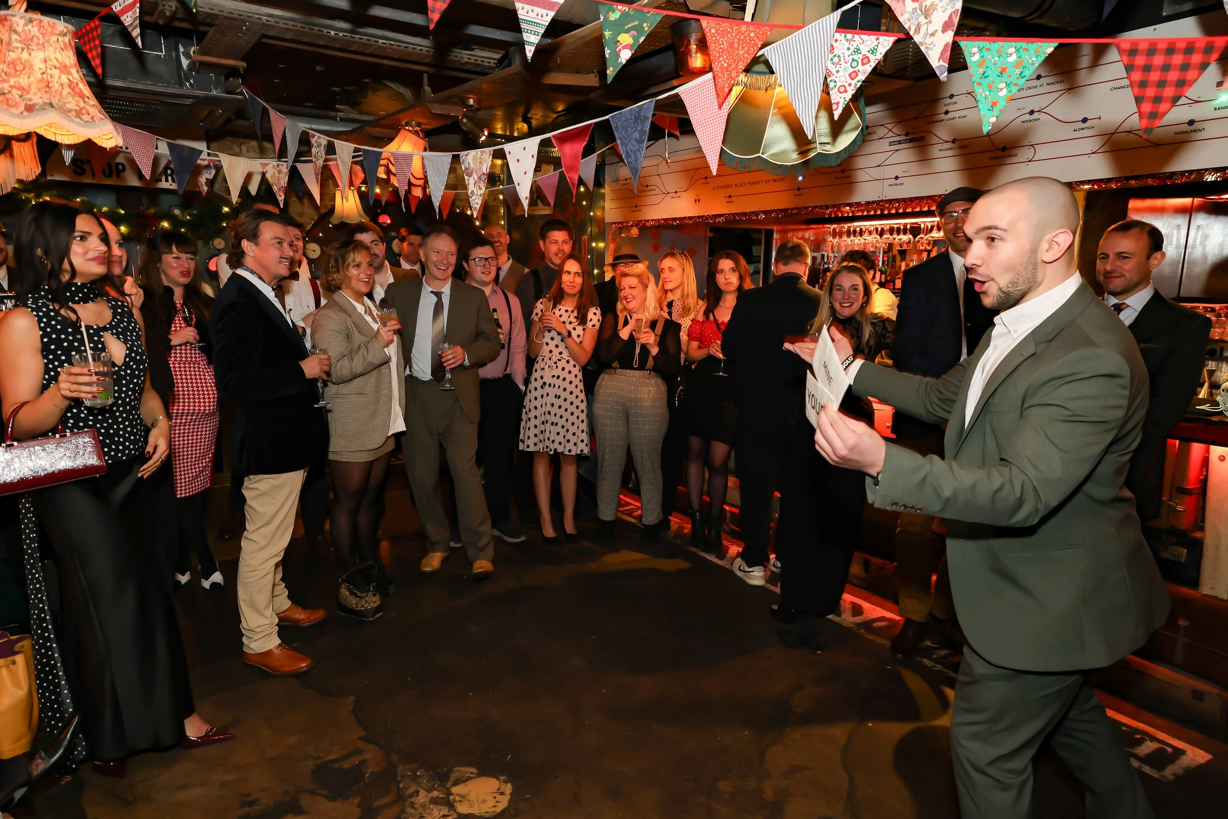 Magician performing walk-around magic for guests at reception.