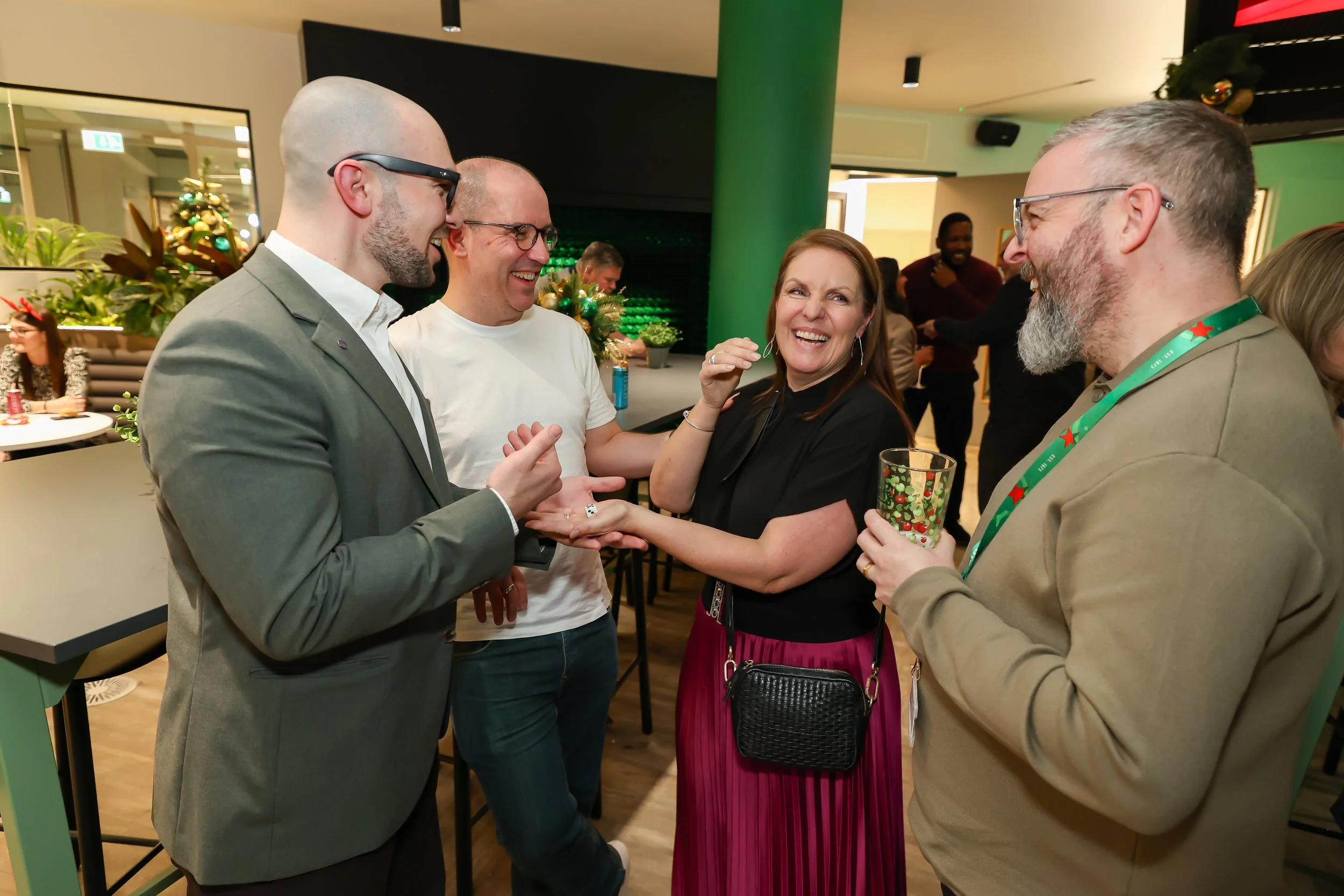 London magician presents a close-up illusion as corporate guests watch in amazement.