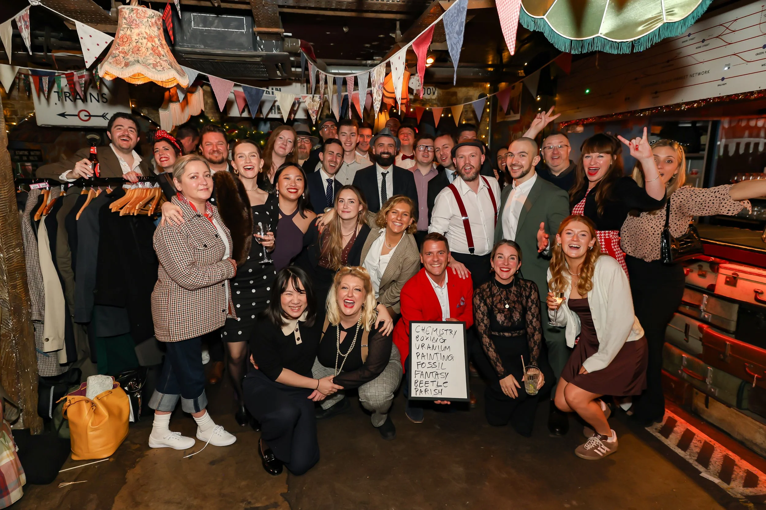 Event magician captured in a group photo with company staff at a corporate function.