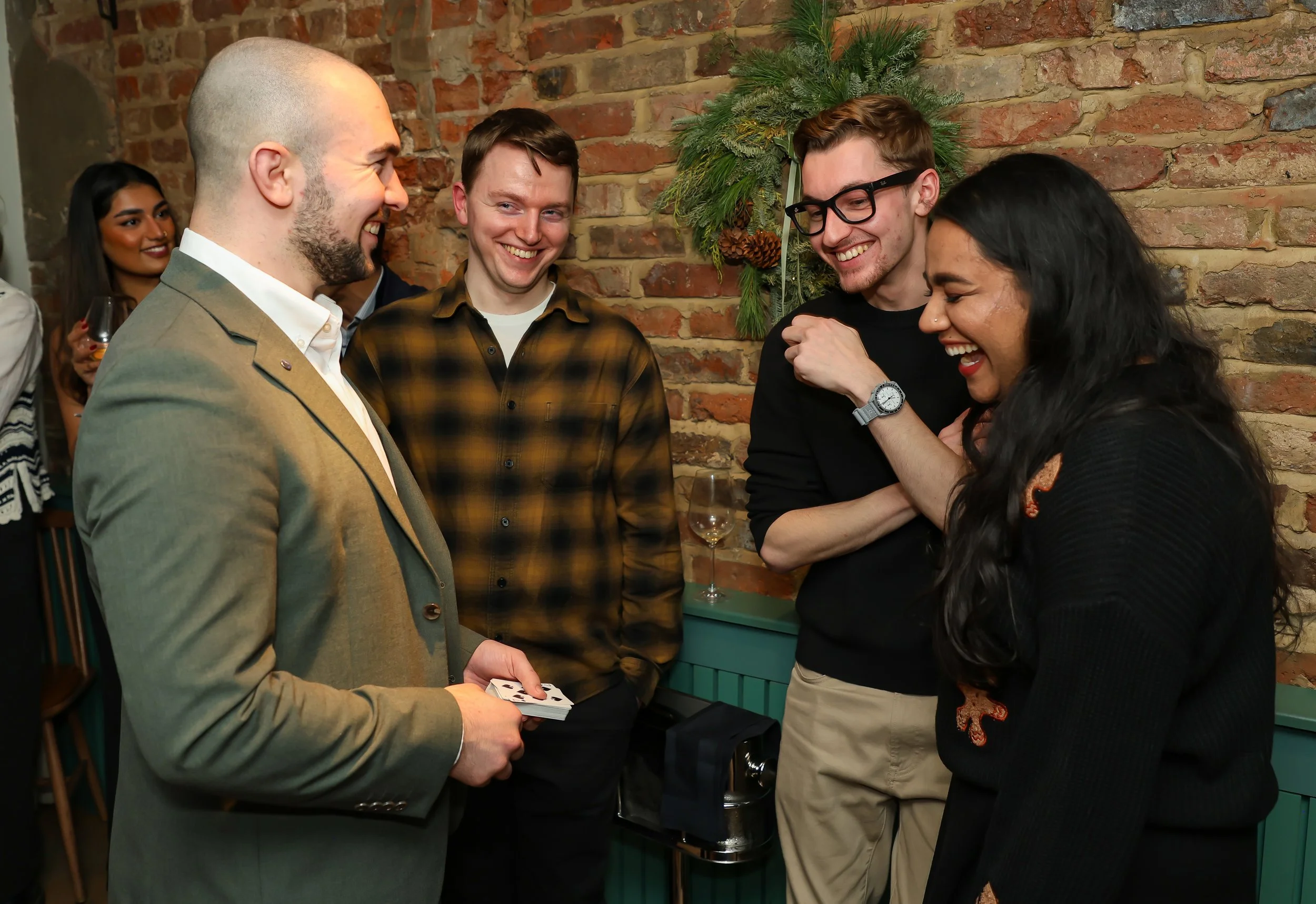 Intimate interactive magic entertaining guests with light-hearted moments and reactions.