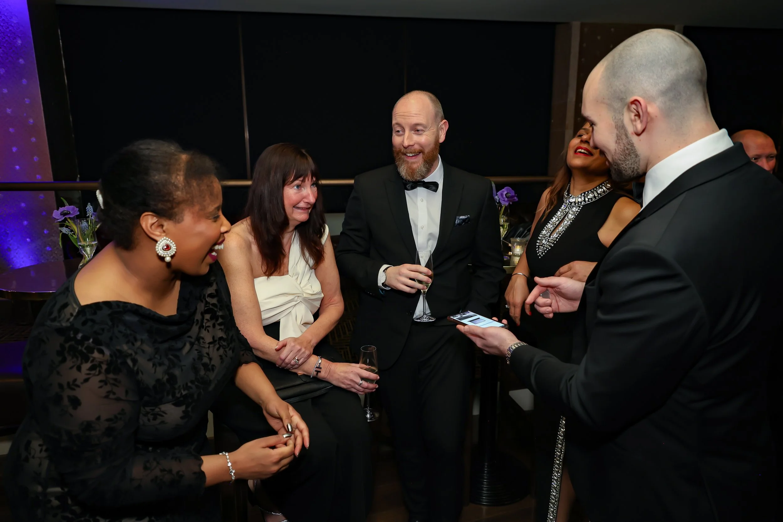 Magician engaging corporate professionals with a live card performance.