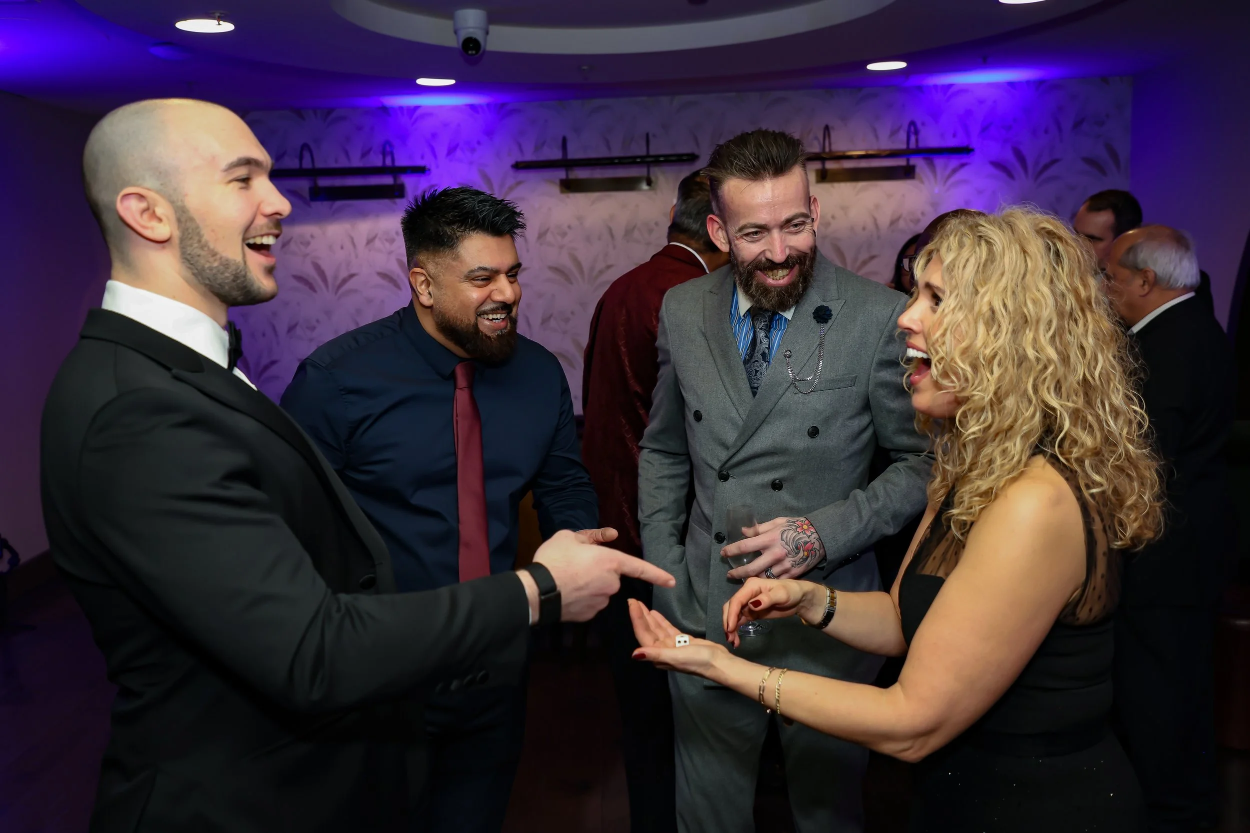 Magician captivating corporate employees with a close-up trick routine.