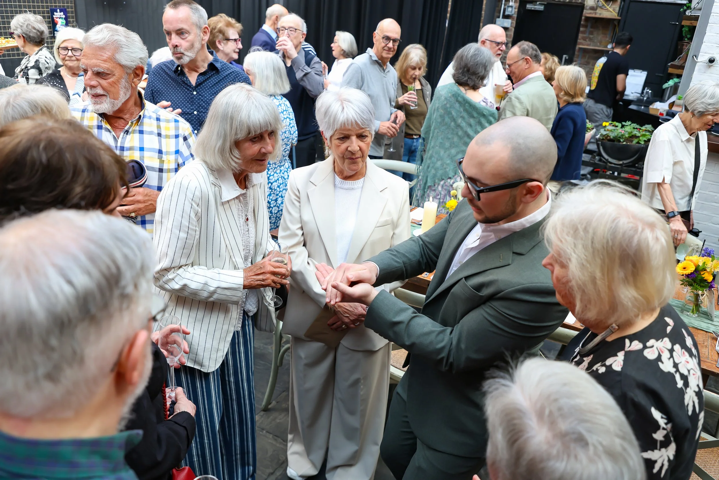 Magician with his card trick. 2026-May 3 Rhoda & Baruch Golden Wedding Anniversary. 