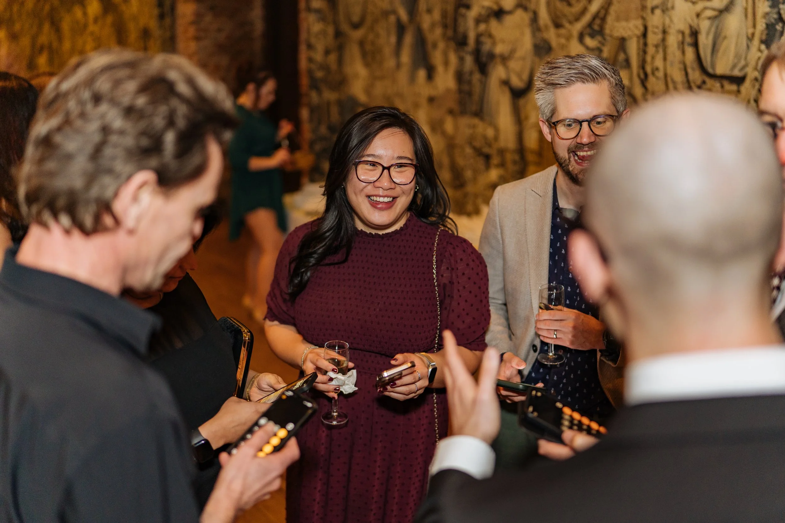 Corporate magician engaging guests in interactive magic at event reception.