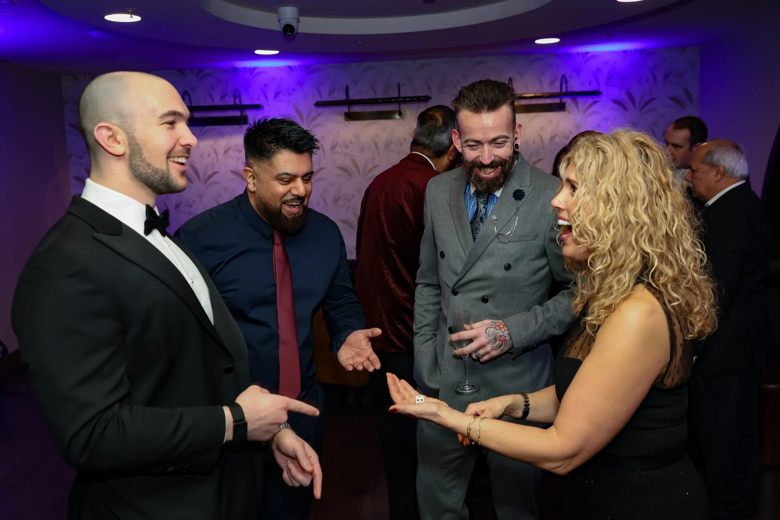 Magician captivating corporate employees with a close-up trick routine.