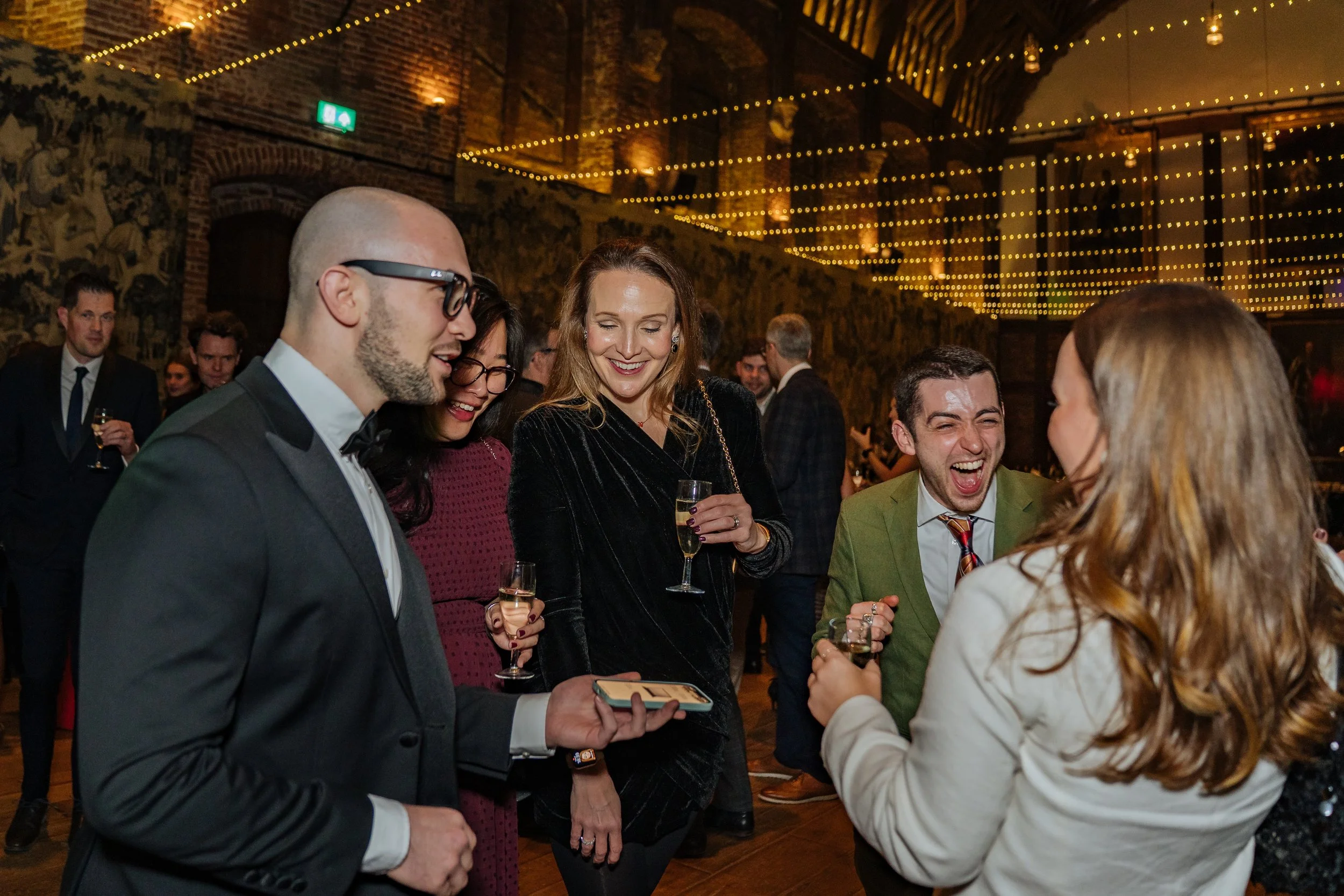 Magician entertaining corporate guests with hands-on illusions, creating laughter and amazement during the dinner event.
