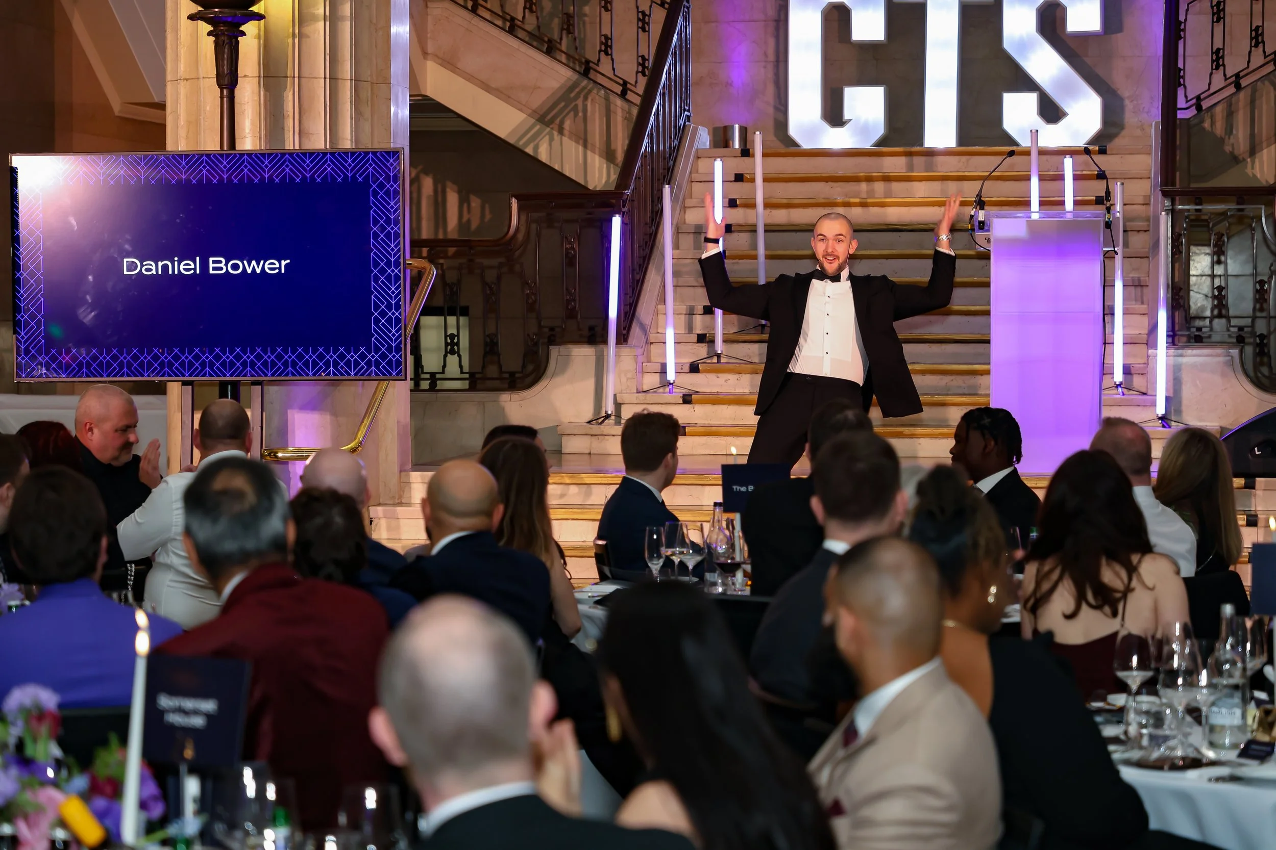 A skilled event host & magician balancing structure and spontaneity to keep the room energised and focused.