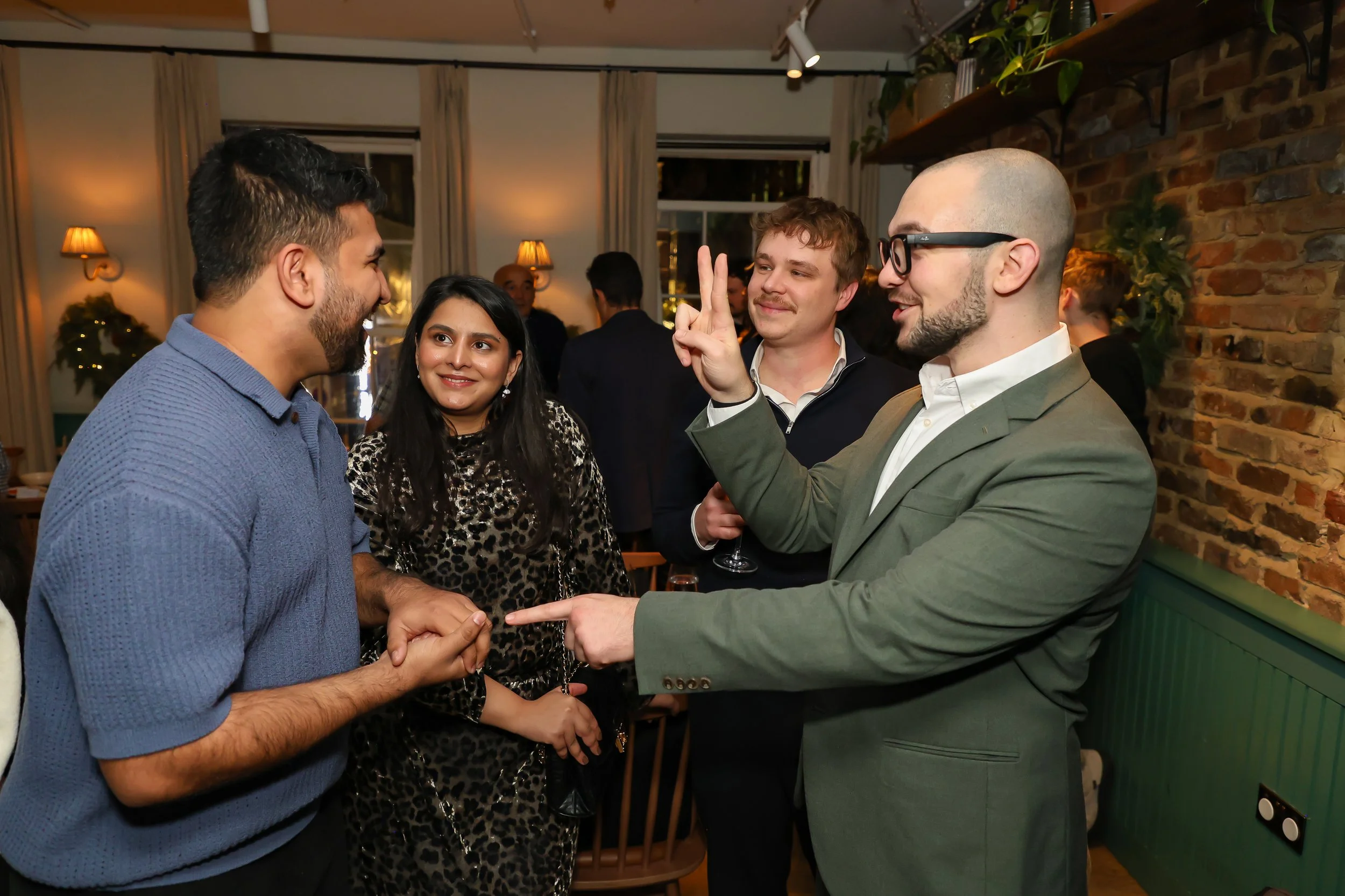 Guests participating in live illusion magic during a corporate reception.